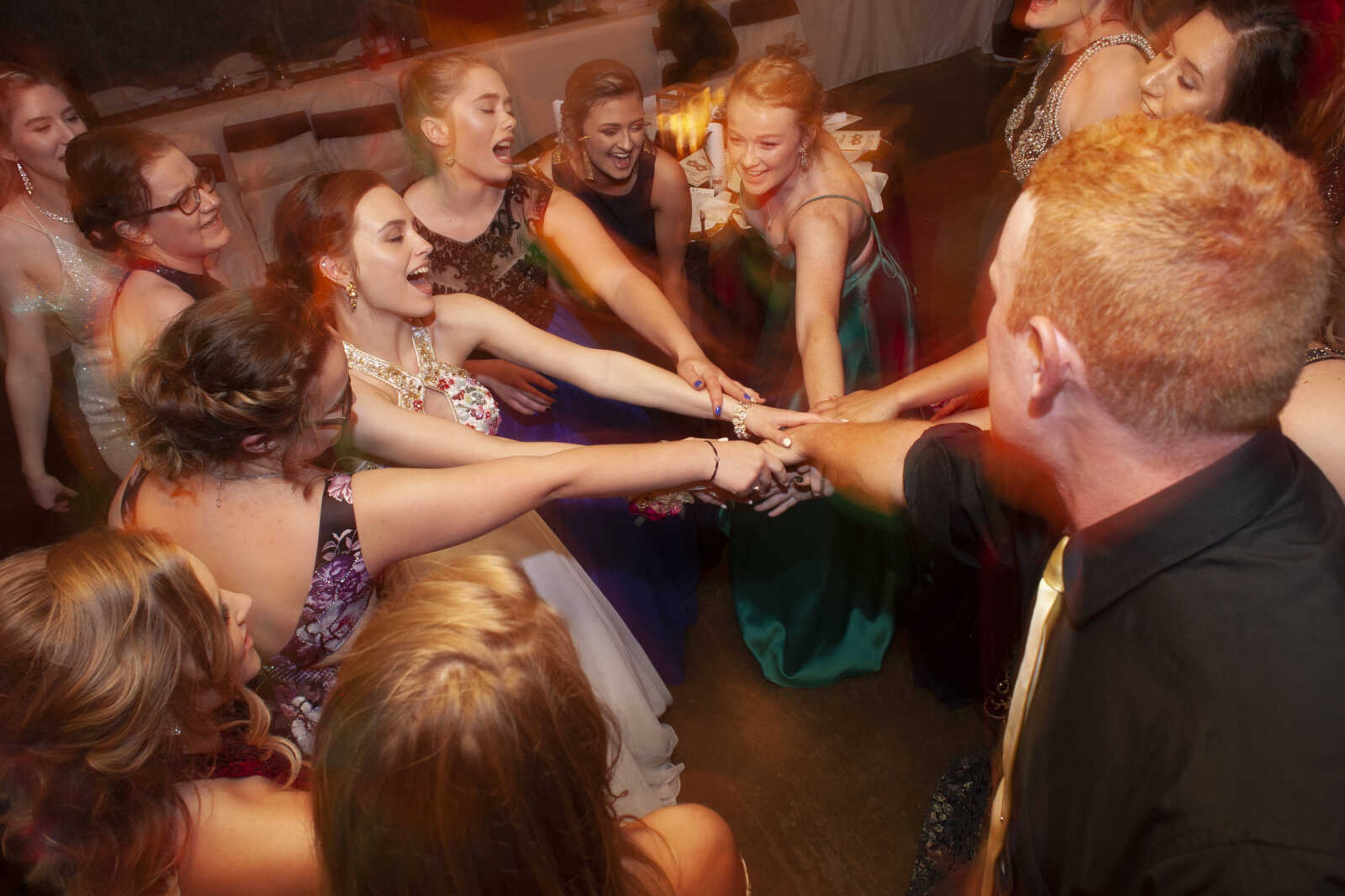 Prom guests sing along with Bon Jovi's "Livin' On A Prayer" during Leopold High School's "Masquerade at Midnight" prom Saturday, April 27, 2019, in Leopold.