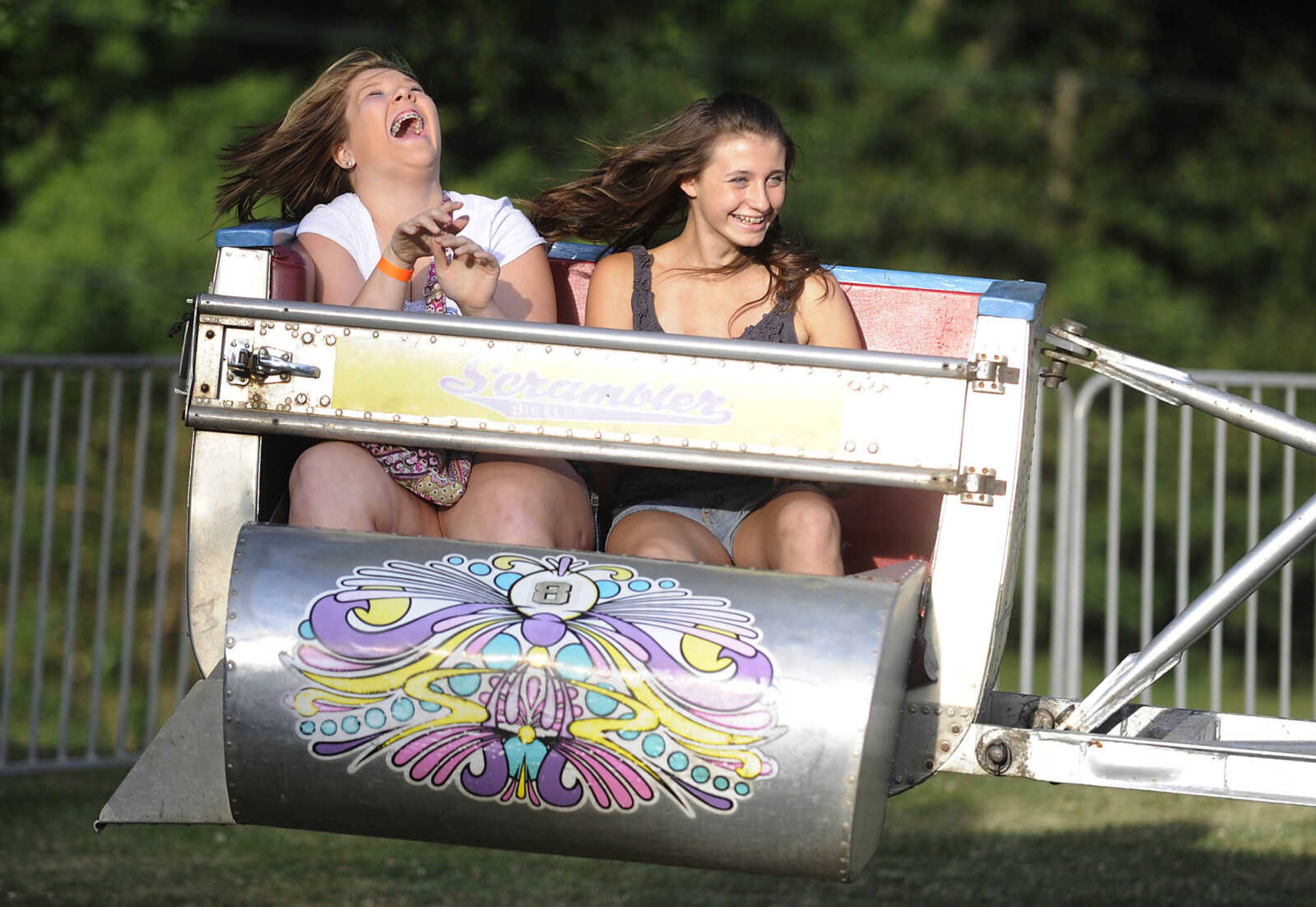 Liz Hensley, 14, and Morgan Pettit, 13, ride the Scrambler at the 36th annual Scott City Summerfest Friday, June 1, at Scott City Park.