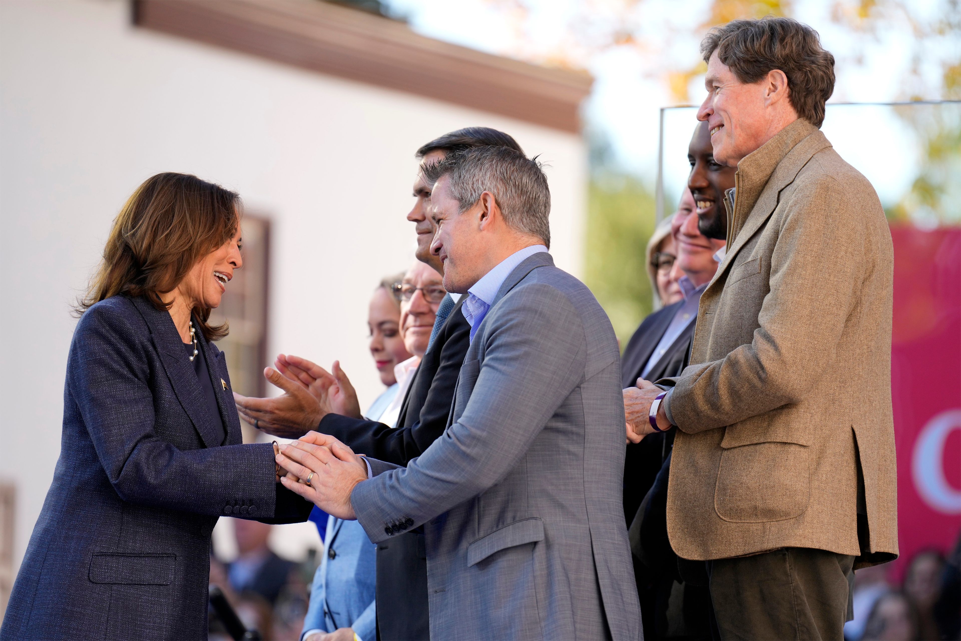 Democratic presidential nominee Vice President Kamala Harris greets former Rep. Adam Kinzinger, R-Ill., before speaking during a campaign event at Washington Crossing Historic Park, Wednesday, Oct. 16, 2024, in Washington Crossing, Pa. (AP Photo/Jacquelyn Martin)