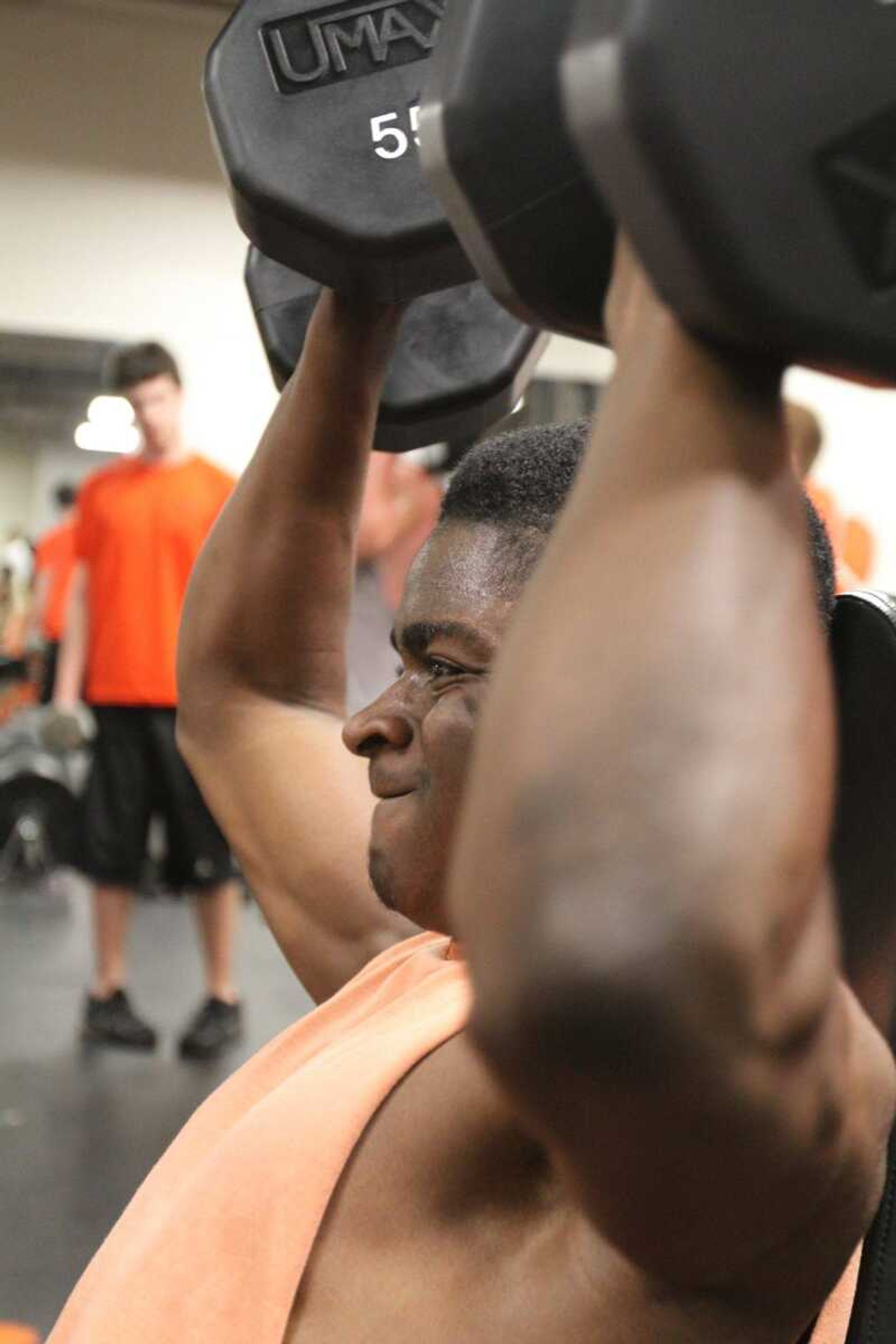 Cape Central's Blake Harris lifts dumbbells with his teammates during a weight lifting workout at Cape Central High School  Wednesday, April 8, 2015. (Glenn Landberg)