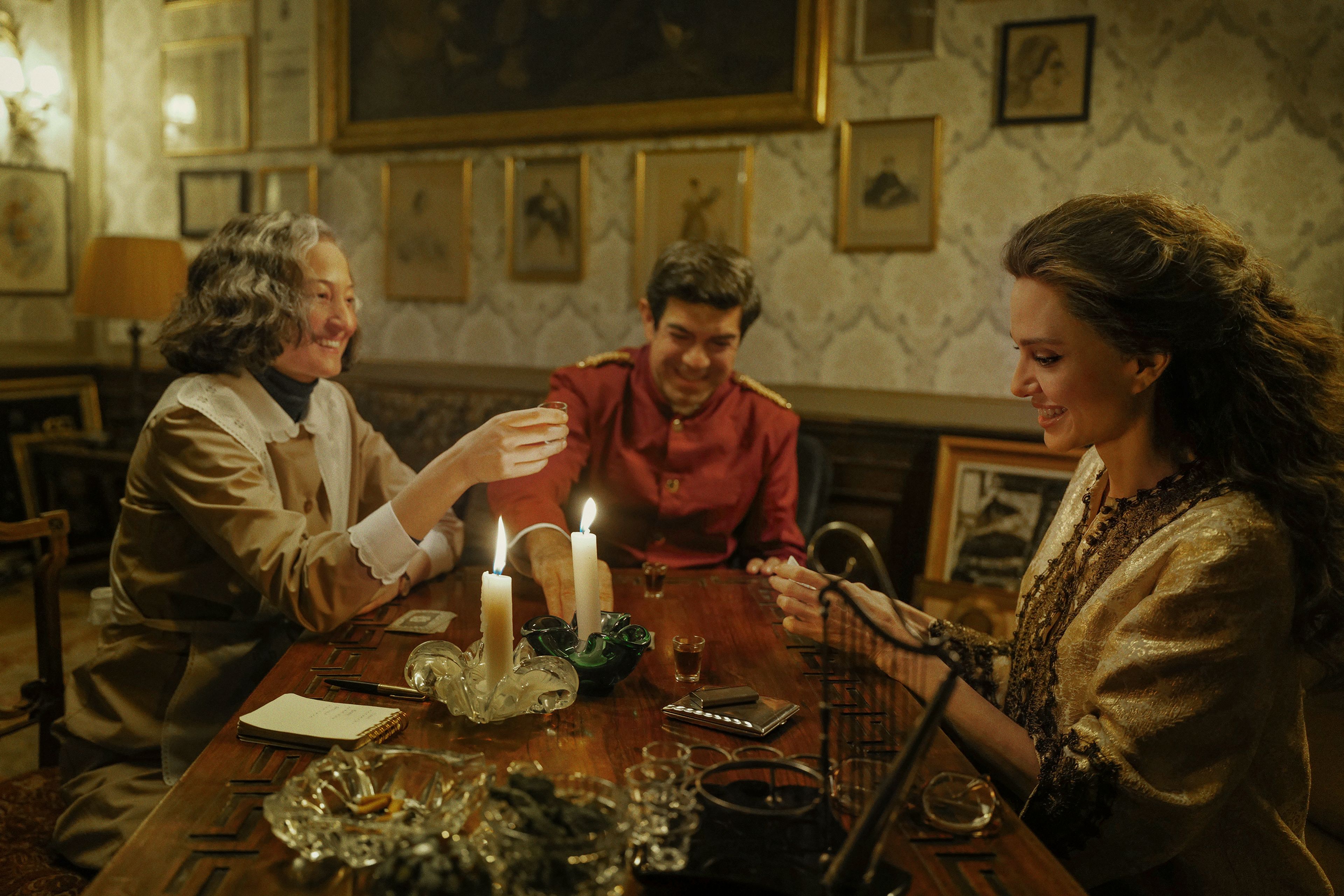 This image released by Netflix shows, from left, Alba Rohrwacher, as Bruna Lupoli, Pierfrancesco Favino, as Ferruccio Mezzadri, and Angelina Jolie, as Maria Callas, in a scene from "Maria." (Pablo Larraín/Netflix via AP)