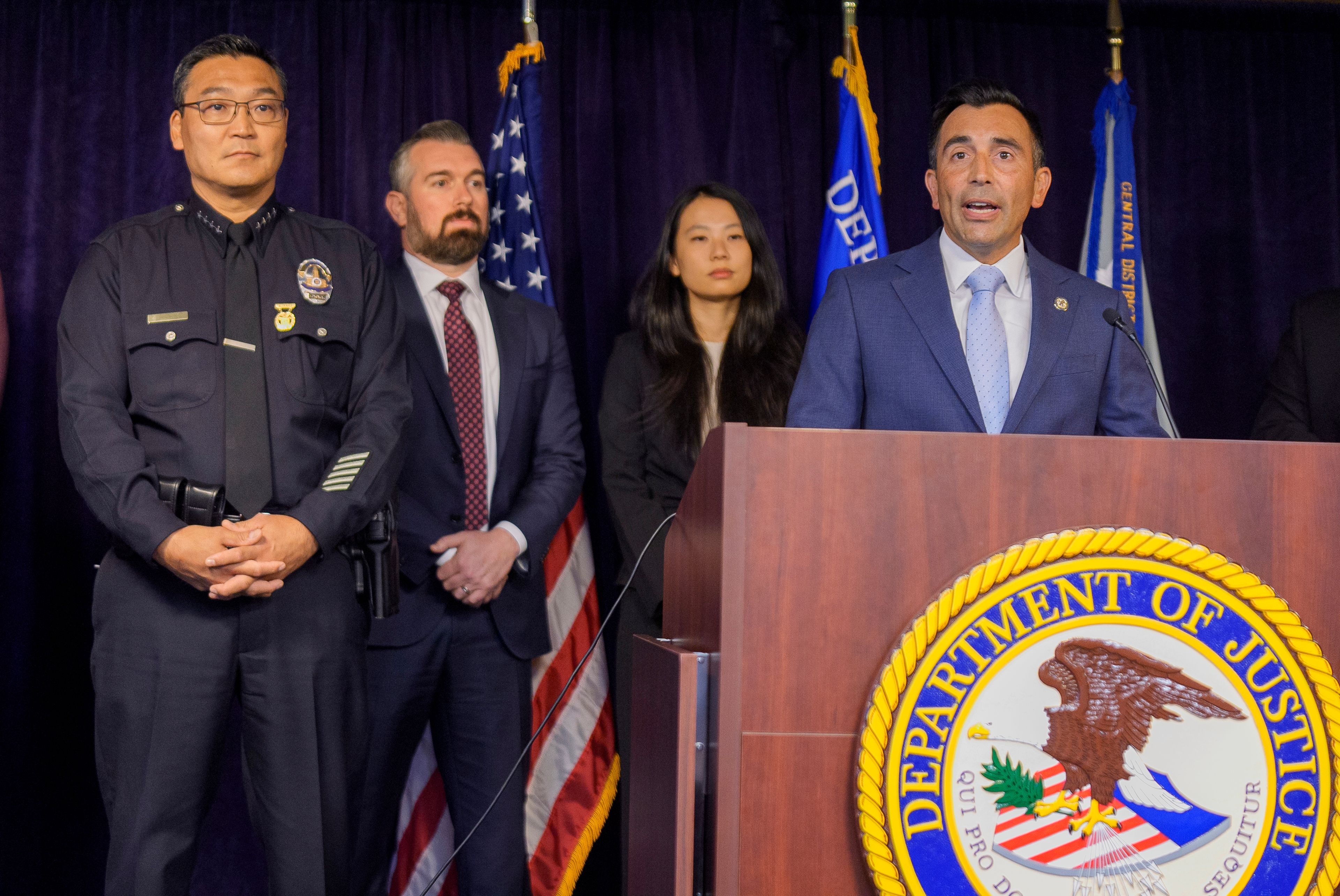 United States Attorney Martin Estrada, at podium, is joined by Los Angeles Police Chief Dominic Choi, far left, and other officials to announce court filings related to the death of actor Matthew Perry in Los Angeles on Thursday, Aug. 15, 2024. (AP Photo/Damian Dovarganes)