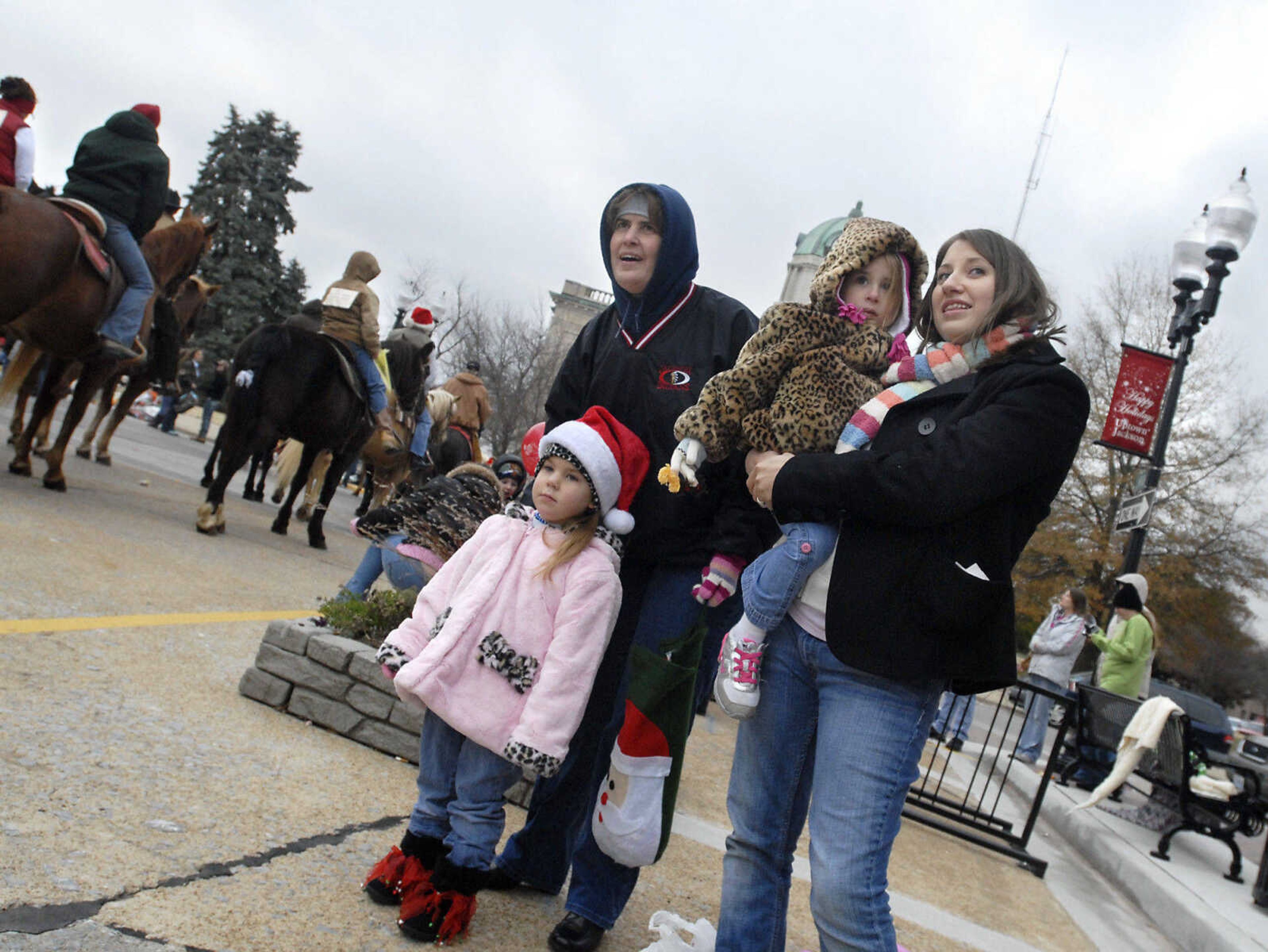 KRISTIN EBERTS ~ keberts@semissourian.com

Pam Stearns, Marandia Rhodes, 3, left, Lexi Stearns, 3, and Jessica Stearns, right, anxiously watch for Santa Claus during the Jackson Christmas Parade on Saturday, Dec. 4, 2010, in downtown Jackson.