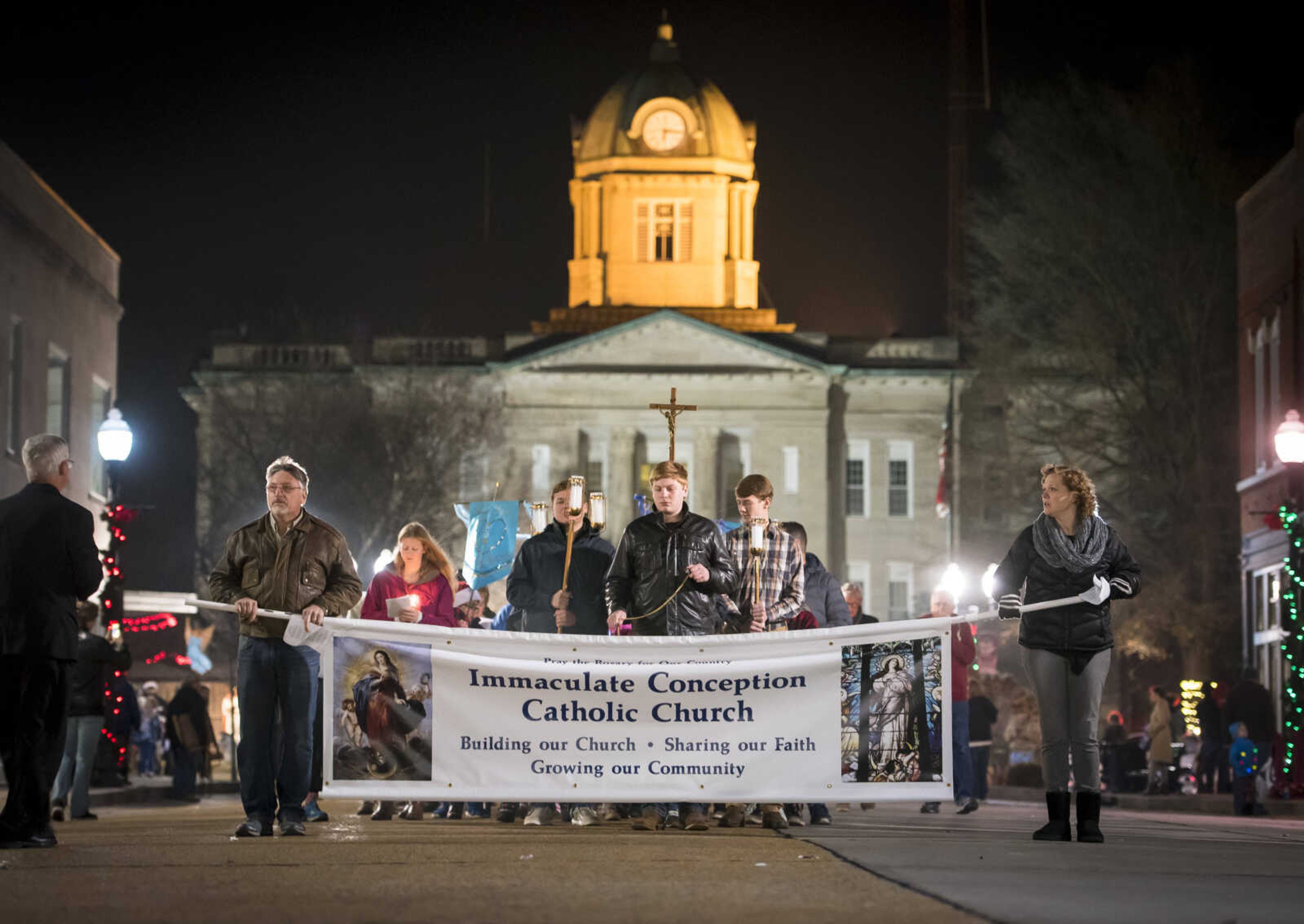 Immaculate Conception Catholic Church members and Catholic clergymen walk in a Marian procession Sunday, Dec. 8, 2019, to recognize the church's 170-year anniversary and to mark the beginning of the church's capital campaign to build a new church building in Jackson.