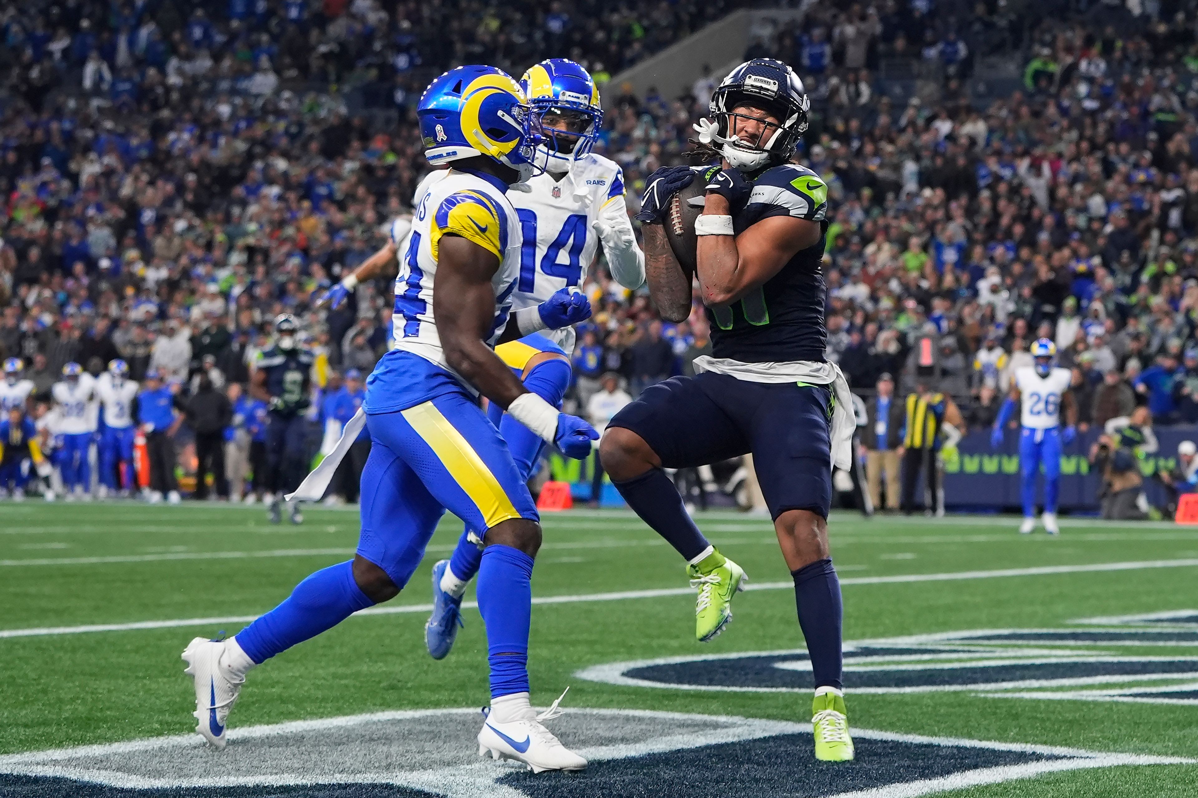 Seattle Seahawks wide receiver Jaxon Smith-Njigba, right, catches a touchdown pass against Los Angeles Rams cornerback Darious Williams, left, and cornerback Cobie Durant (14) during the second half of an NFL football game in Seattle, Sunday, Nov. 3, 2024. (AP Photo/Lindsey Wasson)