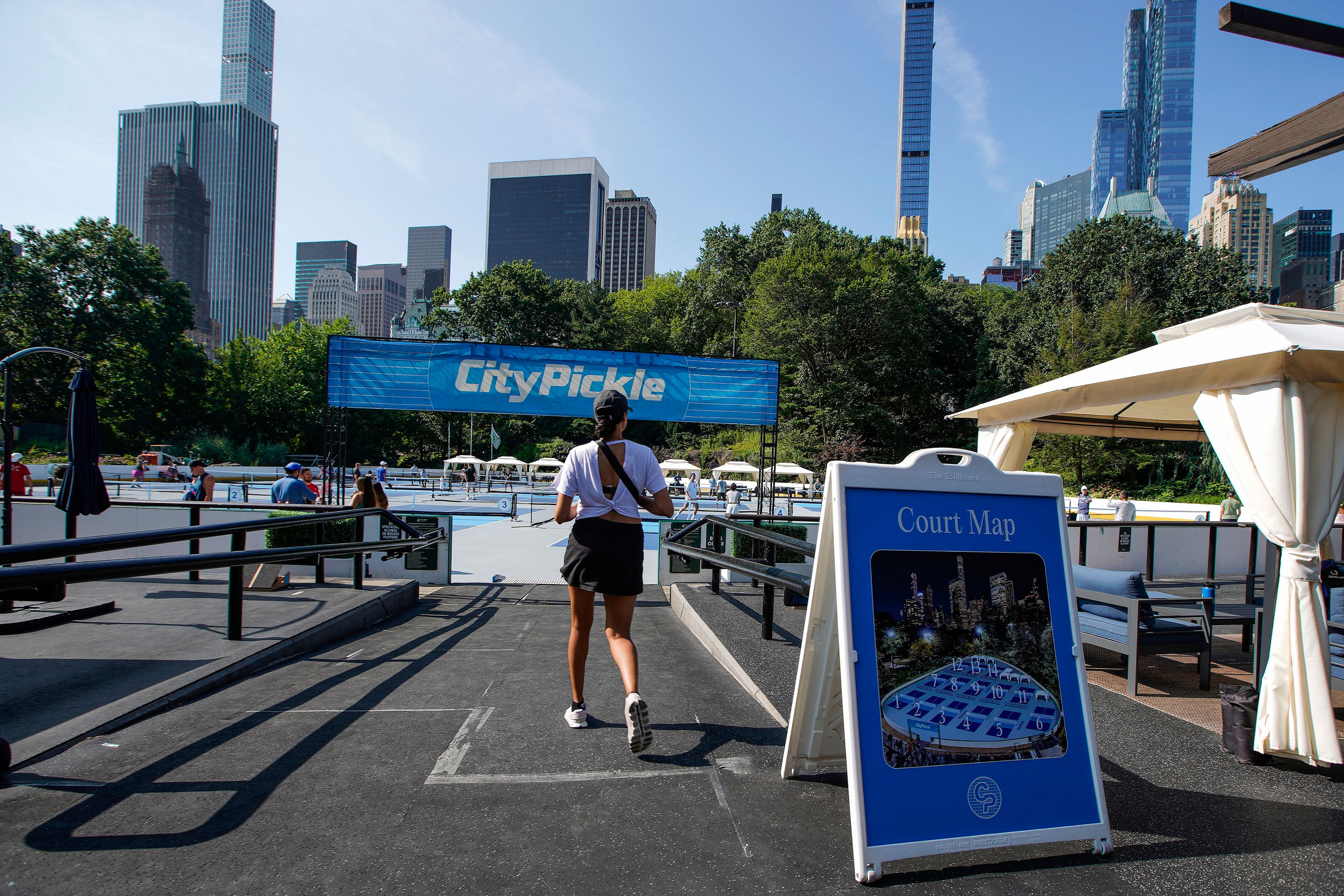 A woman arrives to the courts of CityPickle at Central Park's Wollman Rink, Saturday, Aug. 24, 2024, in New York. (AP Photo/Eduardo Munoz Alvarez)