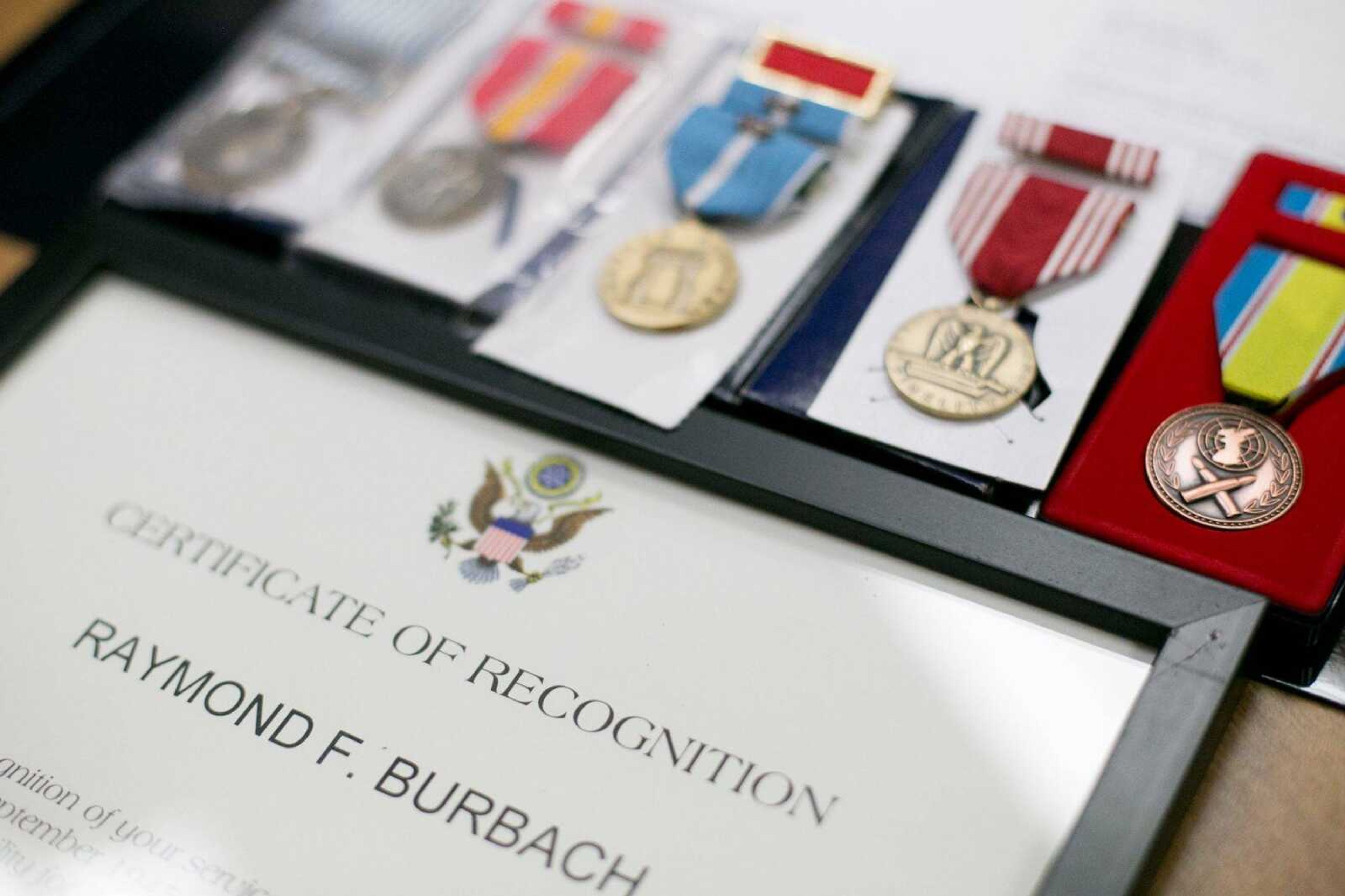 Raymond Burbach's seven awards and accolades rest on a table Wednesday at the Missouri Veterans Home in Cape Girardeau.