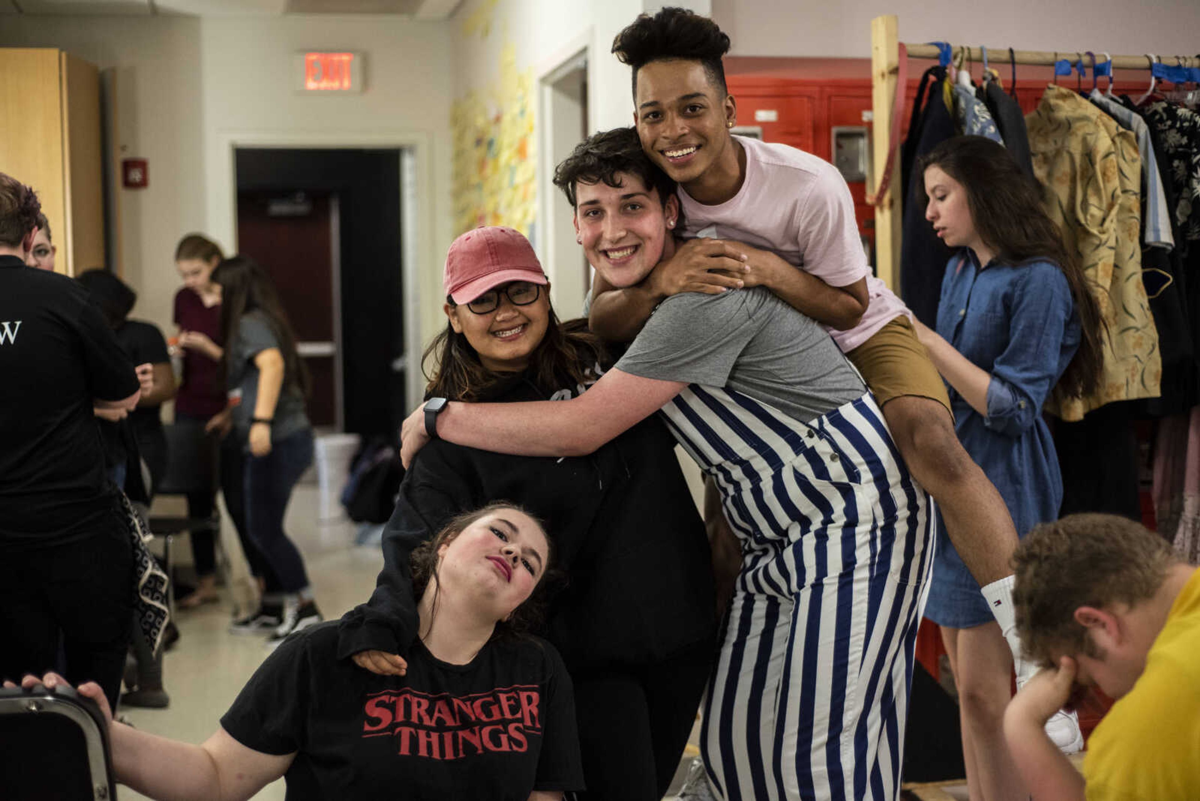 From bottom left, Casey Barwick, 14, Po Nwe, 16, Russell Allen, 18, and Izahia Betancur, 16, smile for a photo before getting ready during the media night of Cape Central High School's spring musical production of "Mamma Mia!" Wednesday, April 10, 2019, in Cape Girardeau.