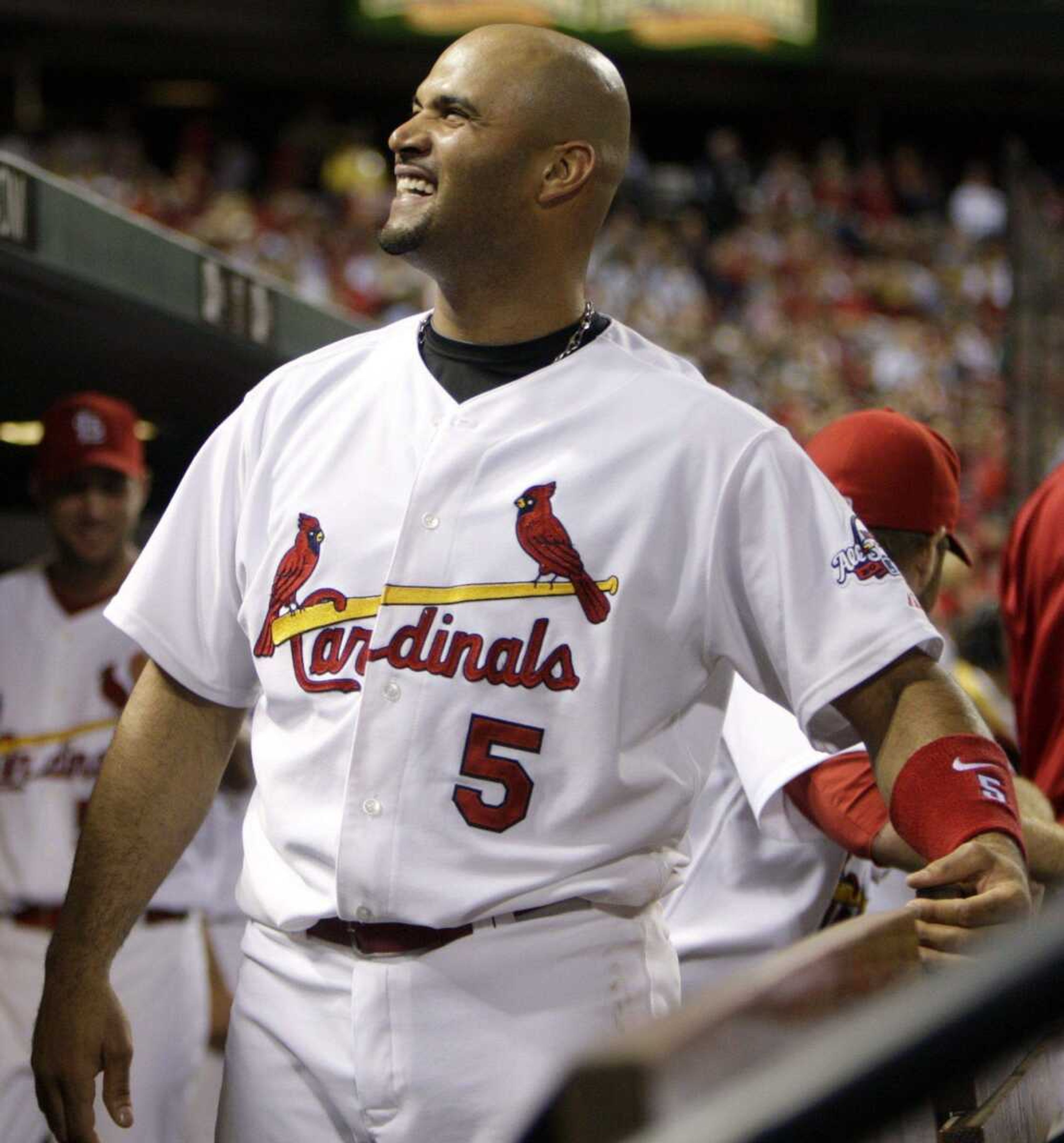 Cardinals first baseman Albert Pujols smiles in the dugout during the sixth inning Tuesday in St. Louis. (JEFF ROBERSON ~ Associated Press)