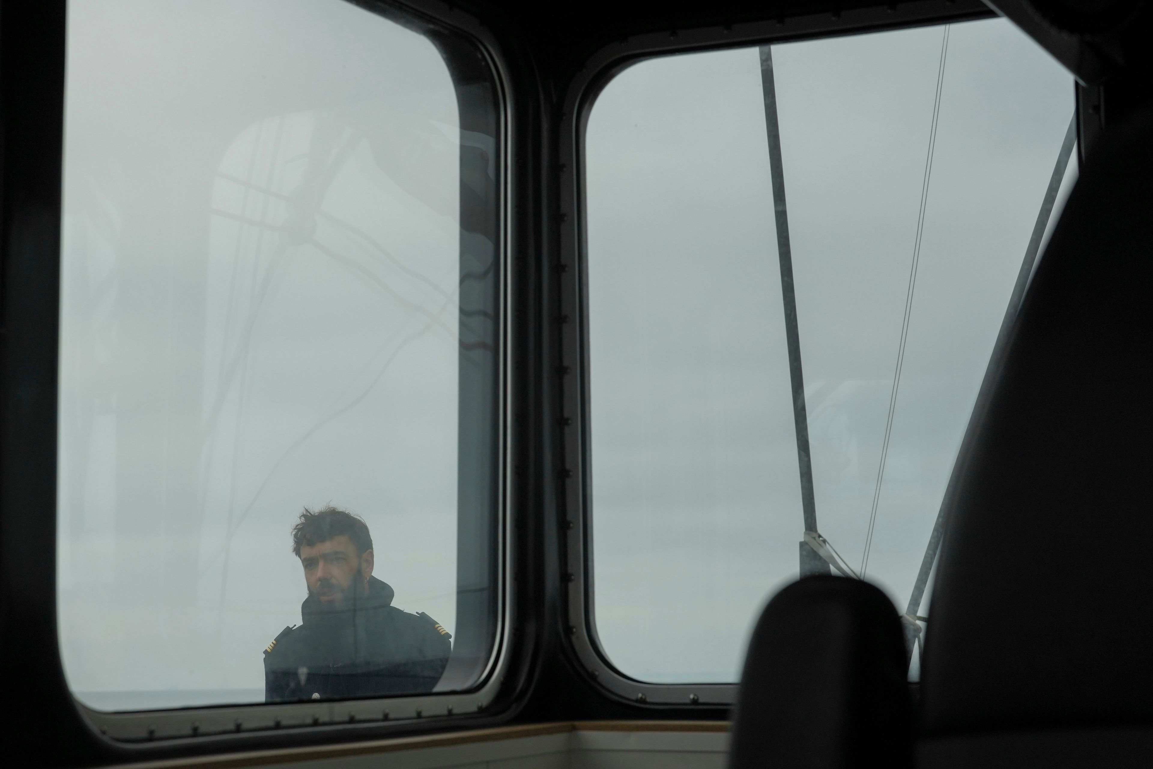 Captain of the Sailboat 'Grain de Sail II' Yann Jourdan stands on the deck as he sails off Saint Malo, western France, Nov. 6, 2024. (AP Photo/Thibault Camus)