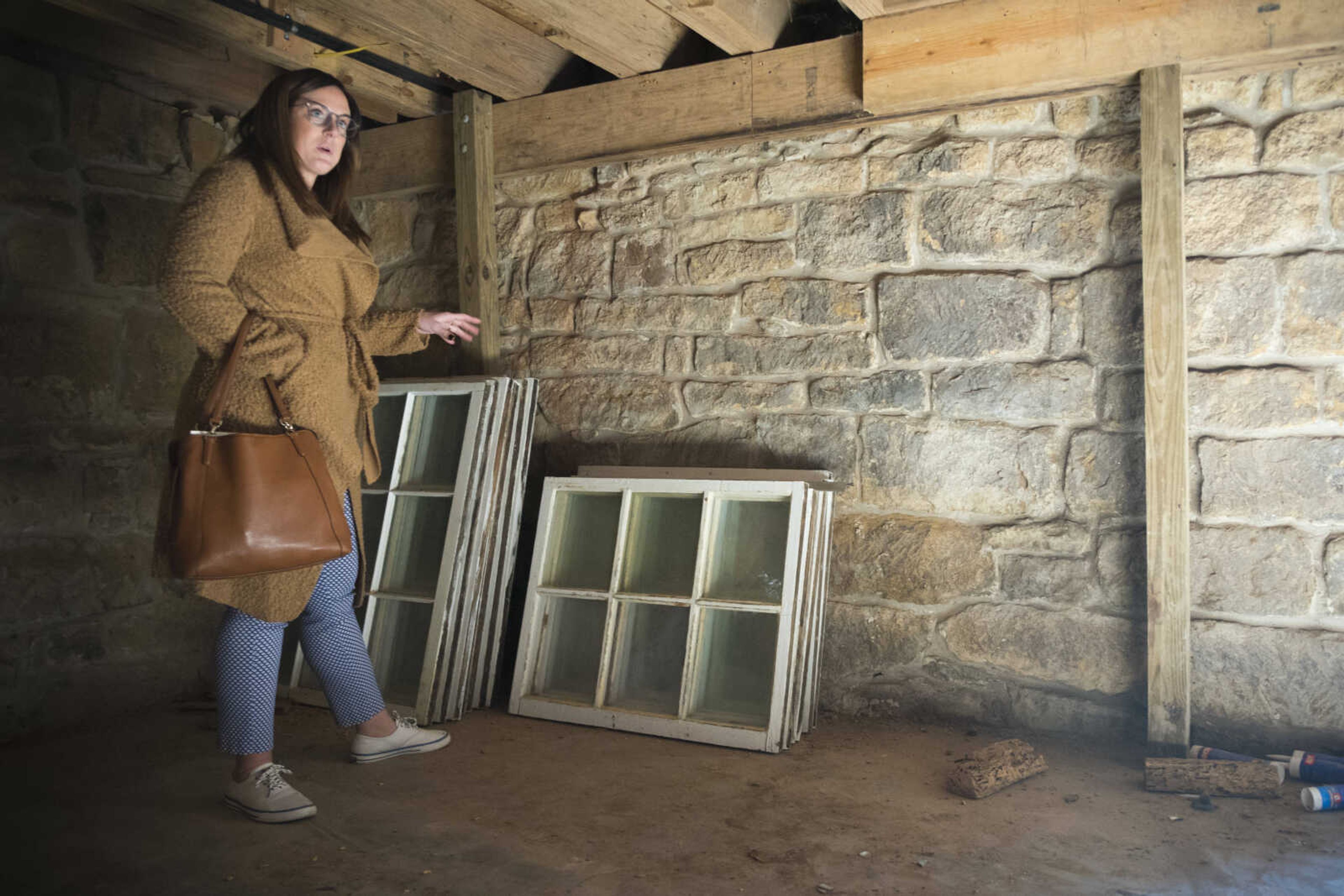 Alyssa Phares, president of the board of directors of the James Reynolds House Foundation, shows a set of original windows in the Reynolds House cellar Monday, Nov. 4, 2019, at 623 N. Main St. in Cape Girardeau.