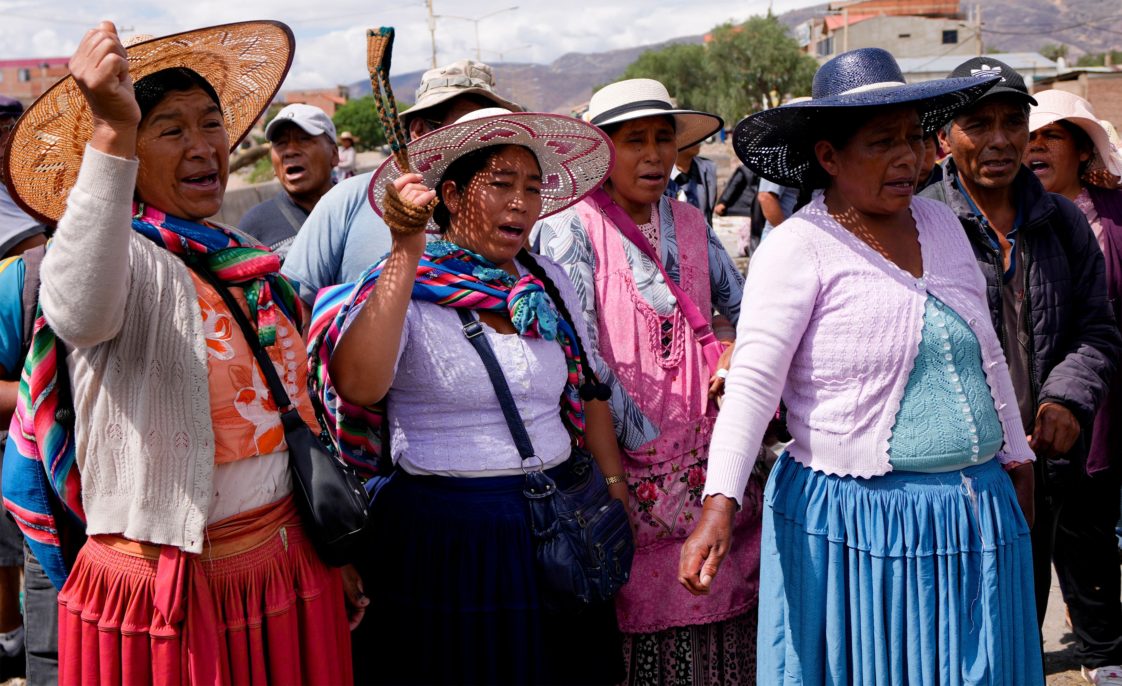 Supporters of Bolivian former President Evo Morales shout slogans as they block a road to prevent him from facing a criminal investigation over allegations of abuse of a minor and to demonstrate against an alleged assassination attempt, near Cochabamba, Bolivia, Monday, Oct. 28, 2024. (AP Photo/Juan Karita)