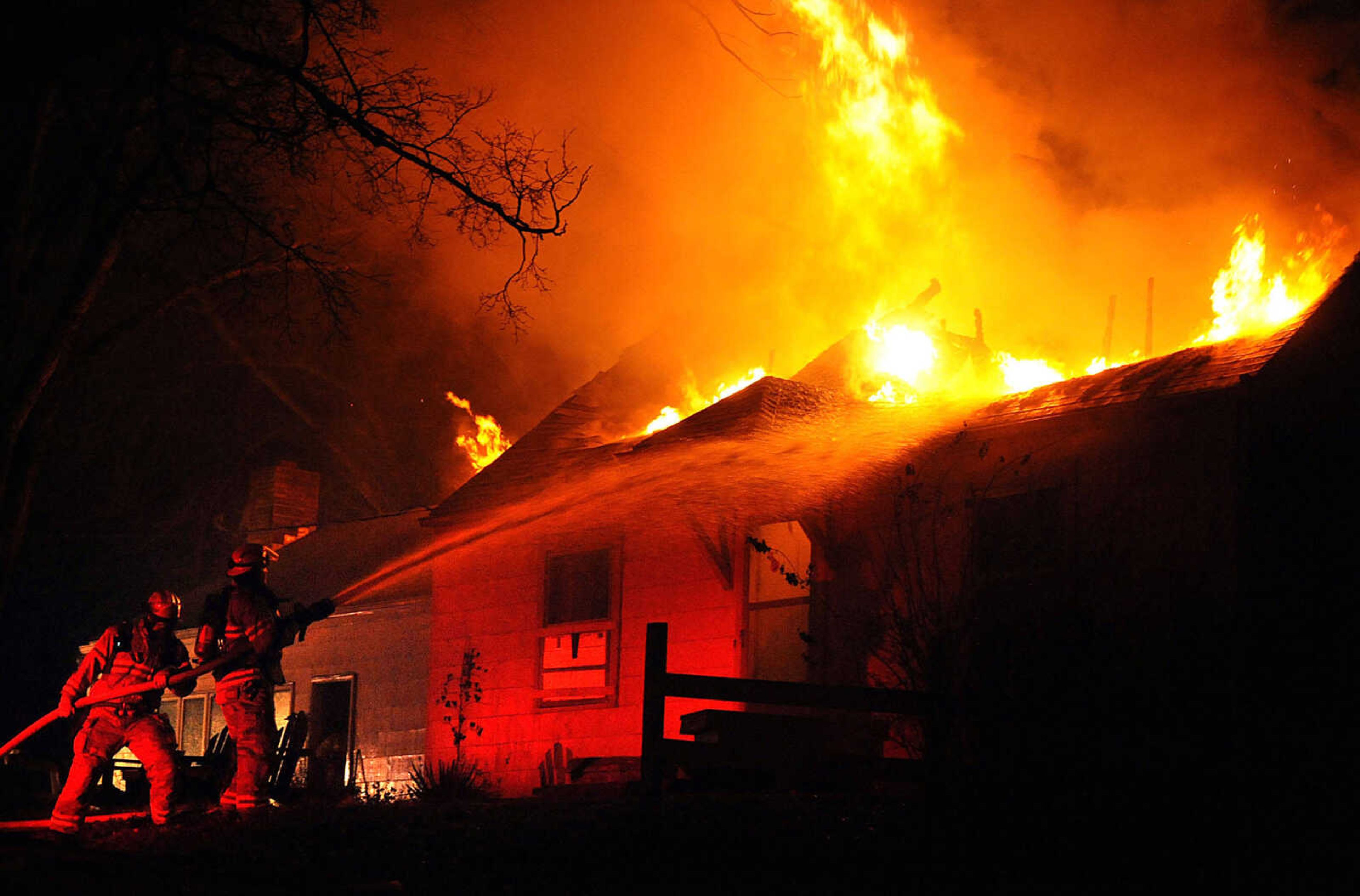 LAURA SIMON ~ lsimon@semissourian.com
Firefighters from Delta, Gordonville, Cape Girardeau, Millersville, Fruitland and East County Fire Departments battle a structure fire Wednesday night, January 9, 2012 on Onyx Lane in Cape Girardeau.