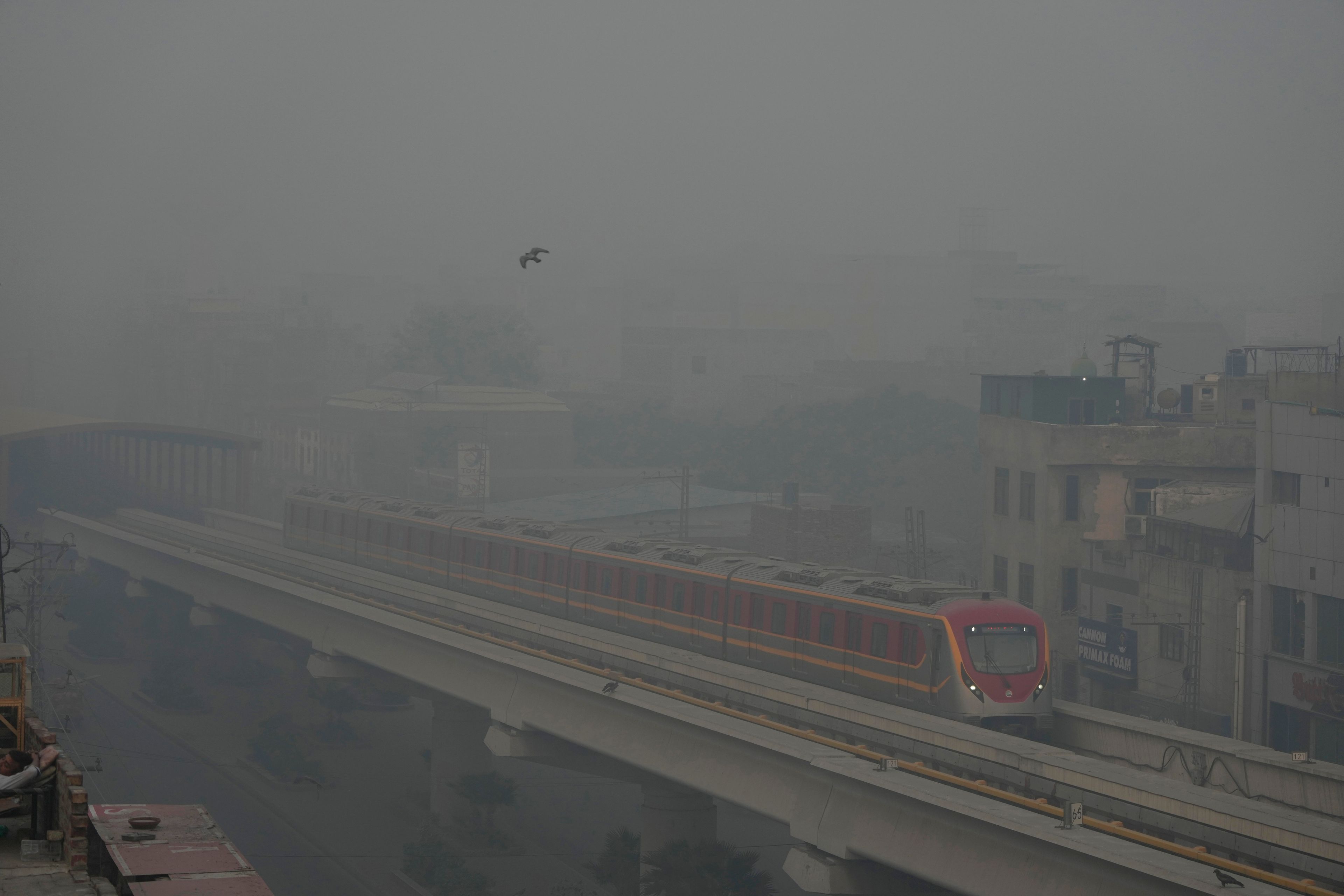 Orange Line Metro Train runs as heavy fog reduces visibility, in Lahore, Pakistan, Sunday, Nov. 3, 2024. (AP Photo/K.M. Chaudary)