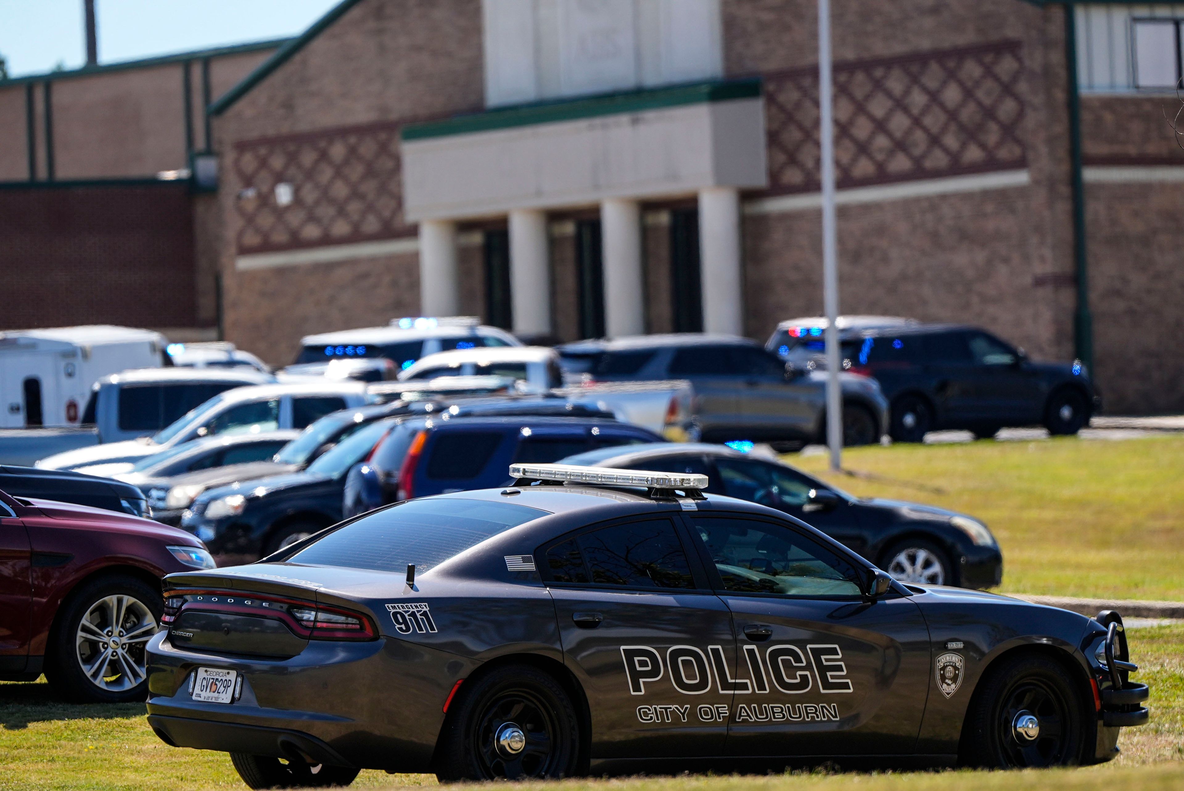 Police vehicles are seen outside Apalachee High School after a shooting there caused an unknown number of injuries and a suspect was arrested Wednesday, Sept. 4, 2024, in Winder, Ga. (AP Photo/Mike Stewart)