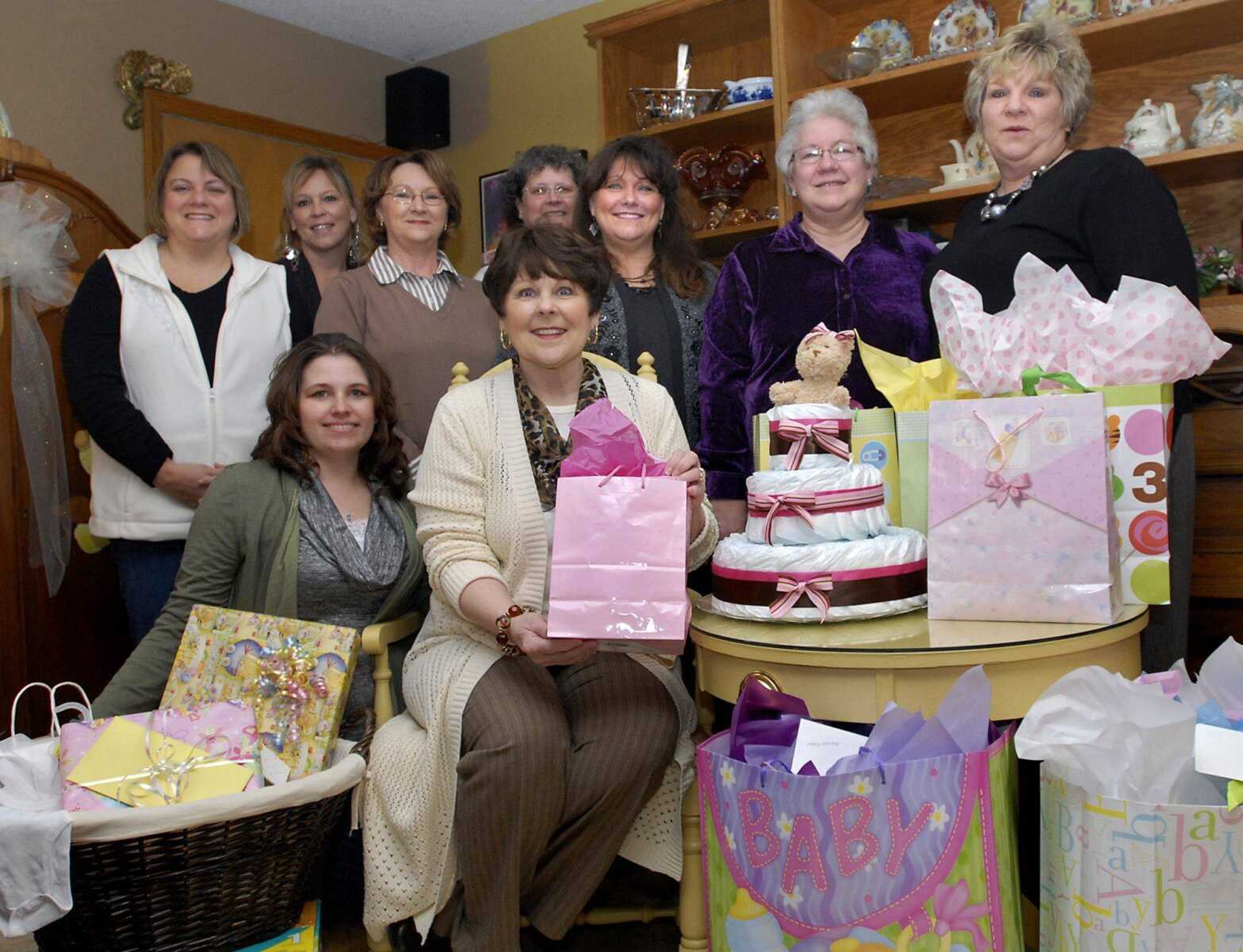 Brenda Moyers, center, of Scott City, celebrated her 65th birthday by holding a baby shower-themed party on Saturday, Jan. 14, 2012. Baby gifts brought by her guests were donated to Birthright. (Kristin Eberts)