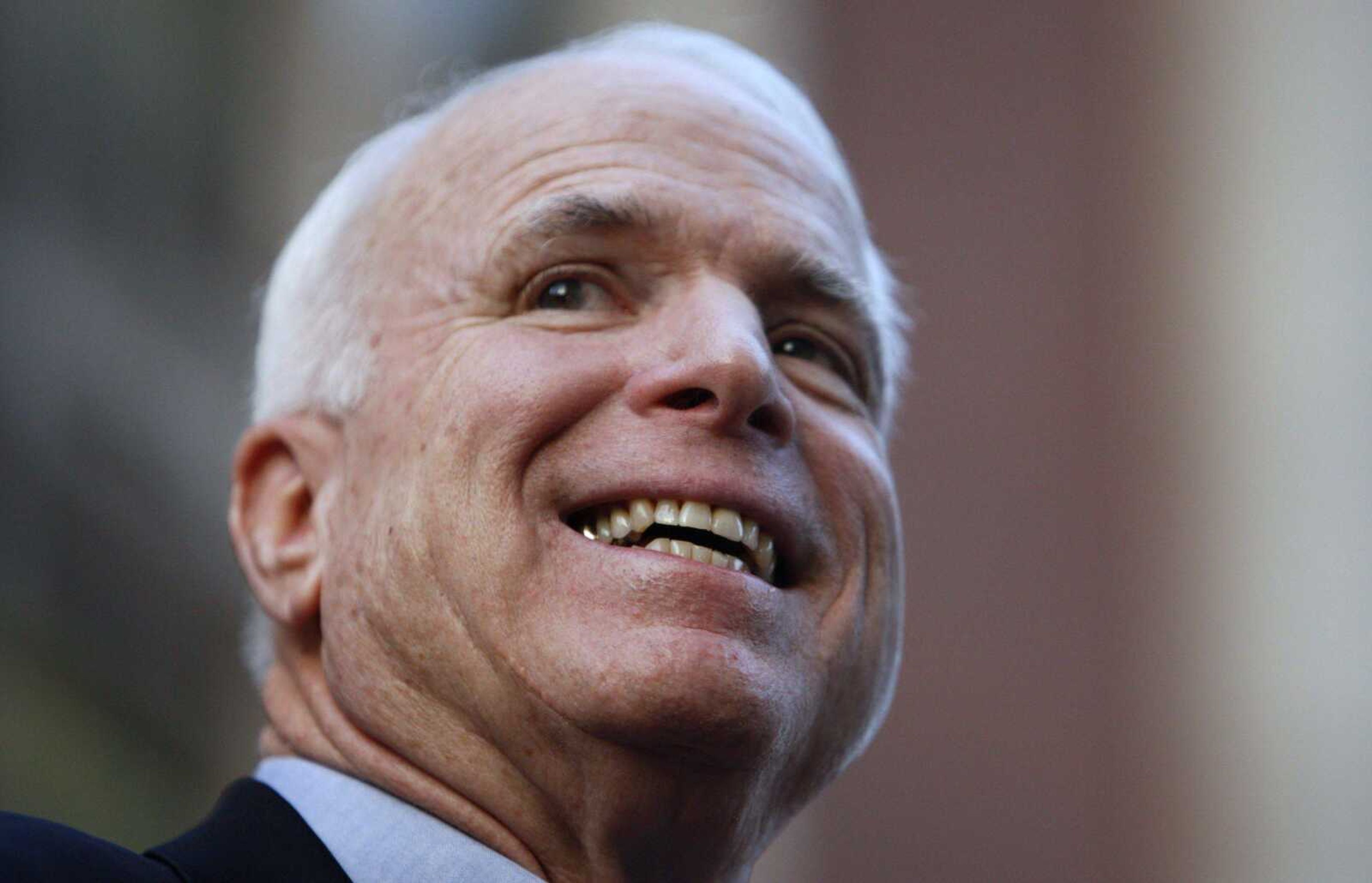 Republican presidential hopeful Sen. John McCain, R-Ariz., smiles as he arrives at a campaign rally in downtown Manchester, N.H., Monday, Jan. 7, 2008. (AP Photo/Charles Dharapak)