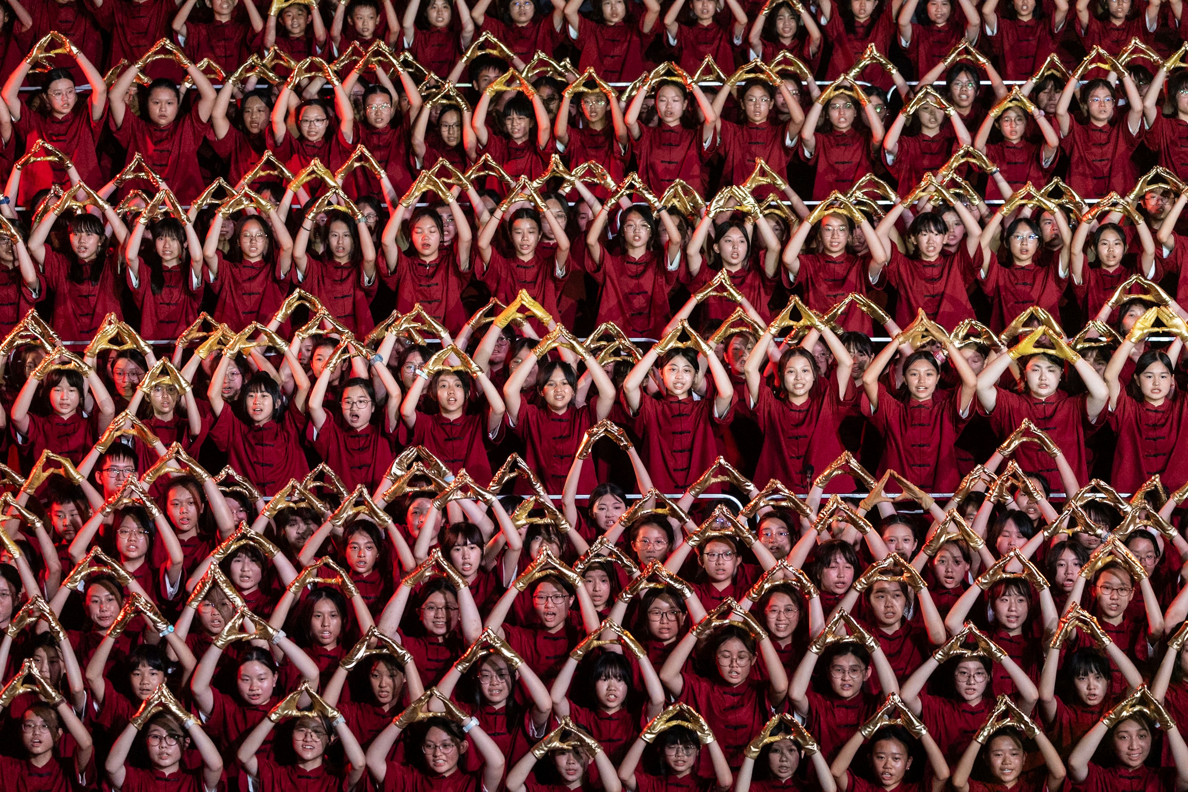 Participants attend the chorus performance as part of the celebration of the national day in Hong Kong, Monday, Sept. 30, 2024. (AP Photo/Chan Long Hei)