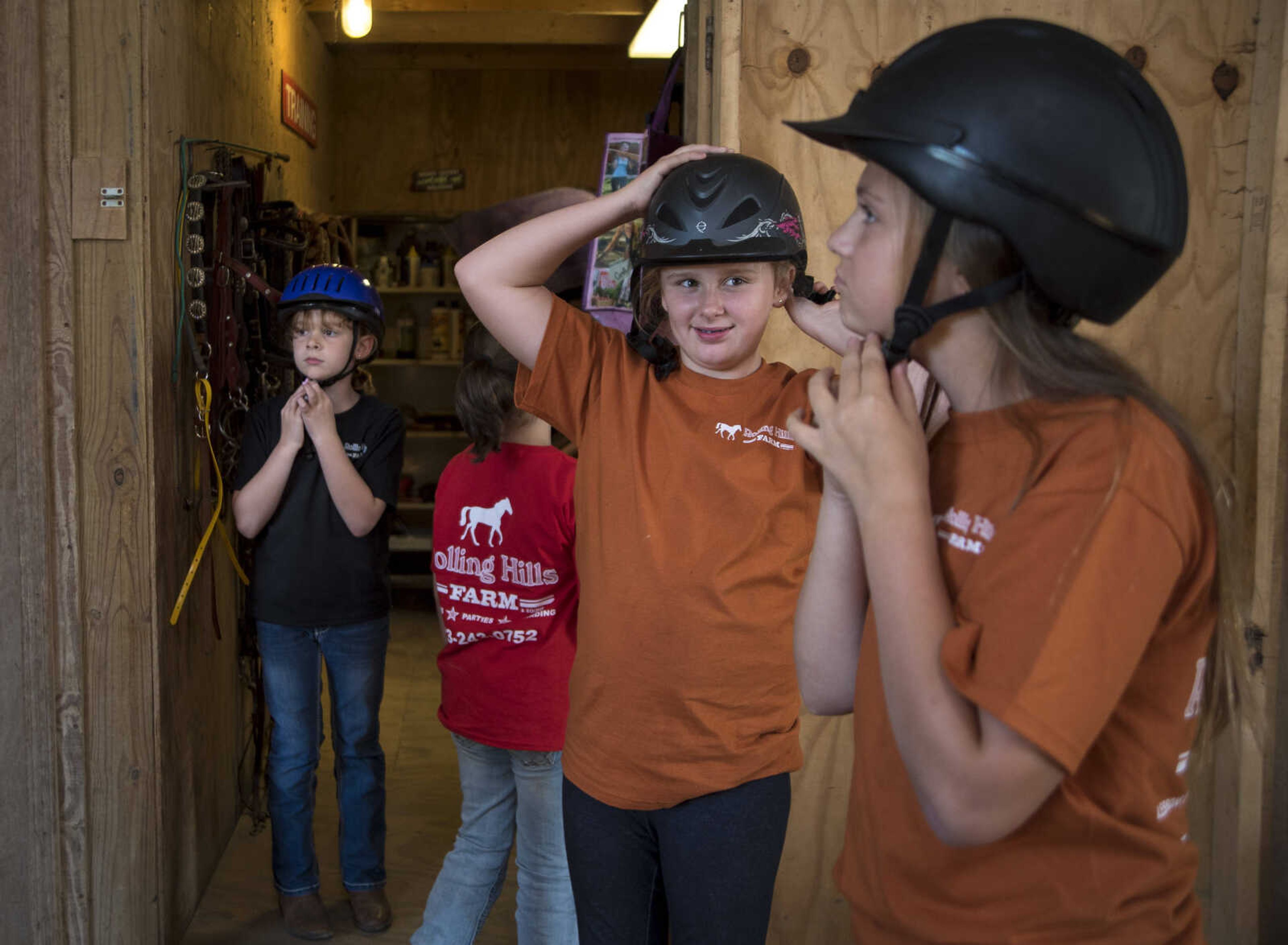 Evelynn LaVenture, 11, and Mia Ahern, 10, put on their helmets during the Rolling Hills Youth Day Camp Wednesday, June 7, 2017 in Cape Girardeau.