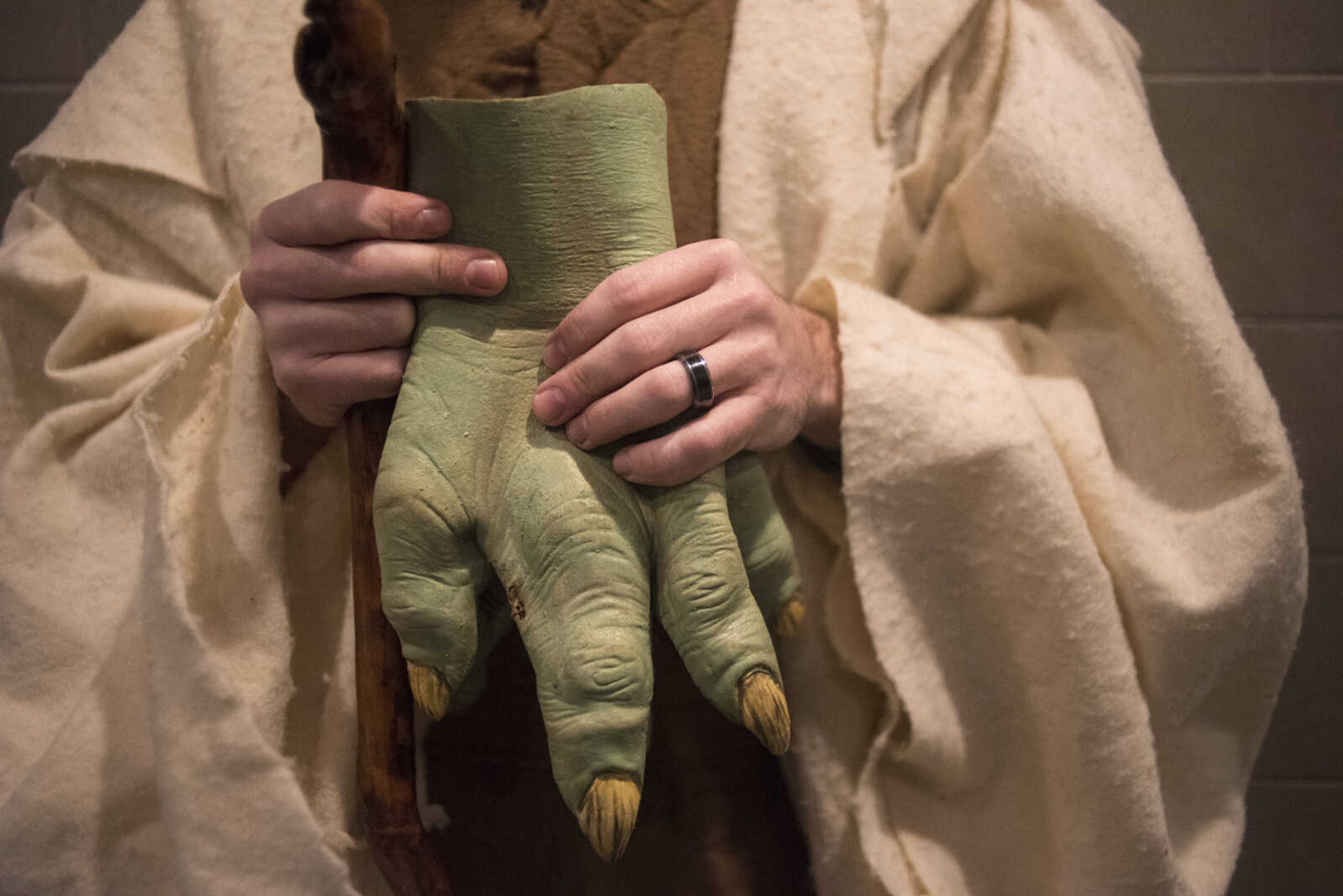 Trey Kerley with the Southern Illinois Jedi Order holds onto his Yoda hands before the showing of Star Wars: The Last Jedi Thursday, Dec. 14, 2017 at Cape West Cinema in Cape Girardeau.