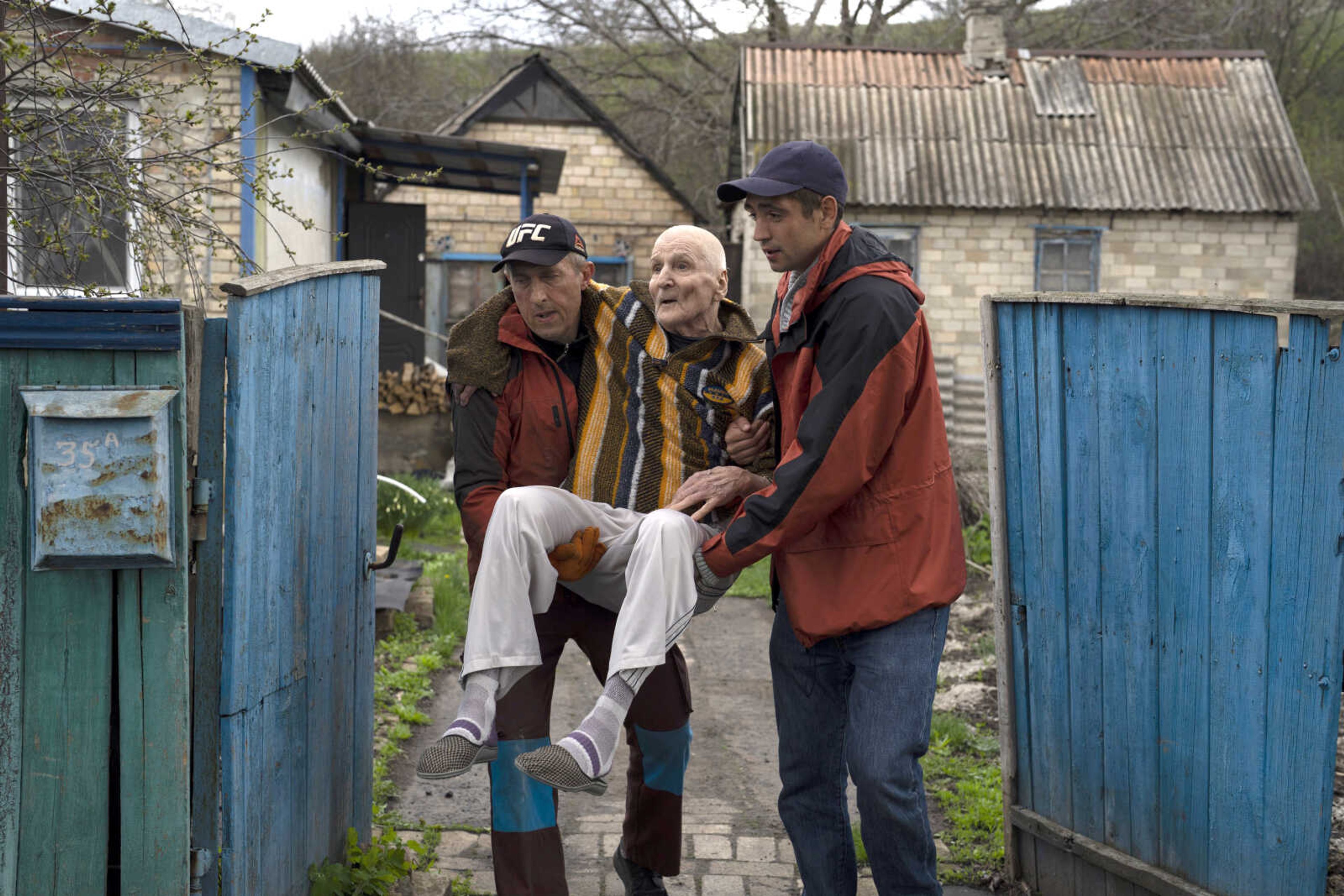 Elderly people are evacuated from a hospice Monday in Chasiv Yar city, Donetsk district, Ukraine. At least 35 men and women, some in wheelchairs and most of them with mobility issues, were helped by volunteers to flee from the region that has been under attack in the last weeks. They are being transported to Khmelnytskyi, in western Ukraine.