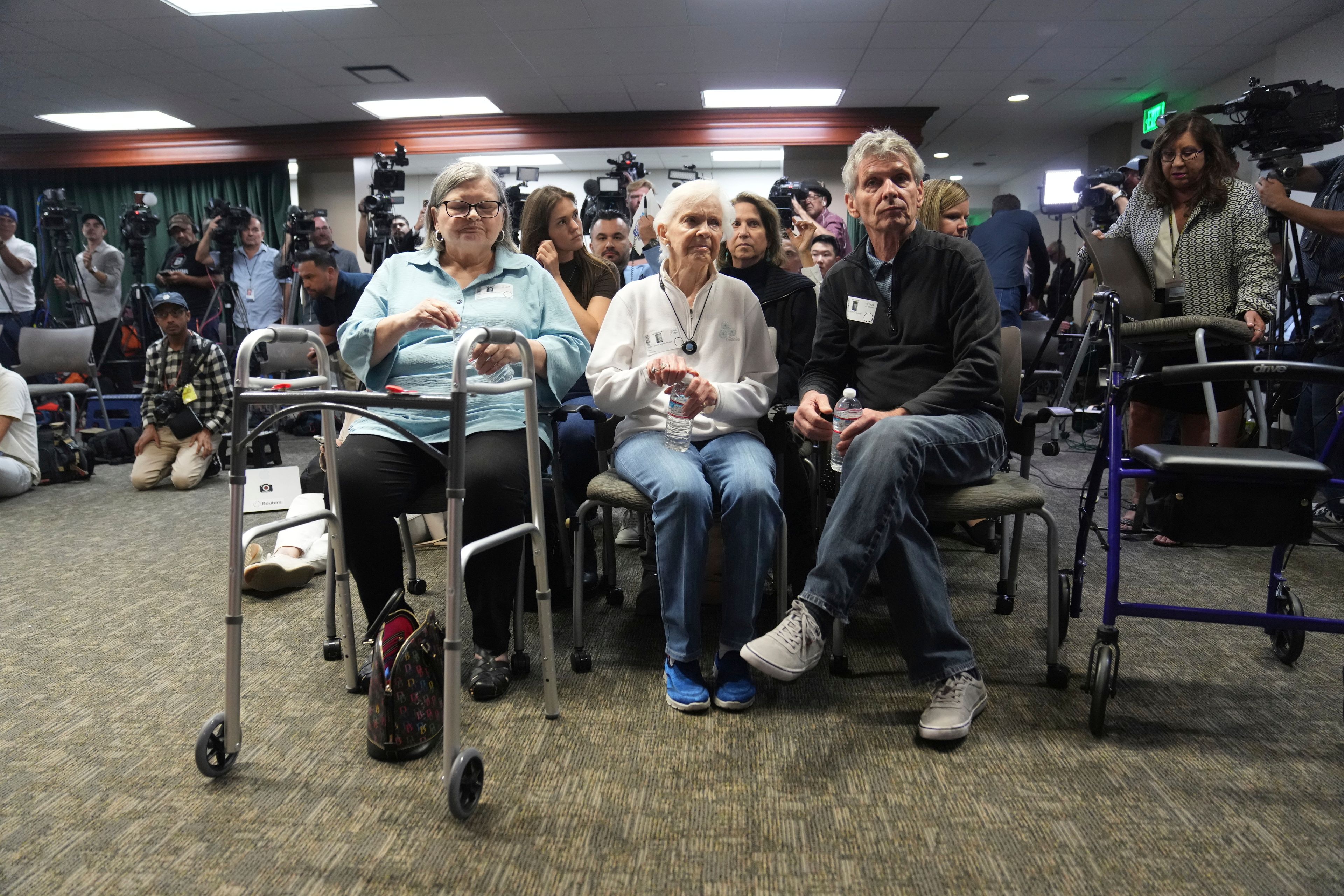 Diane Hernandez niece of Kitty Menendez is joined by Arnold VanderMolen, Nephew of Kitty Menendez, right, and Kitty Menendez's sister, Joan Andersen VanderMolen, center sit at a news conference being held by Los Angeles County District Attorney George Gascon on Thursday, Oct. 24, 2024, in Los Angeles. (AP Photo/Eric Thayer)