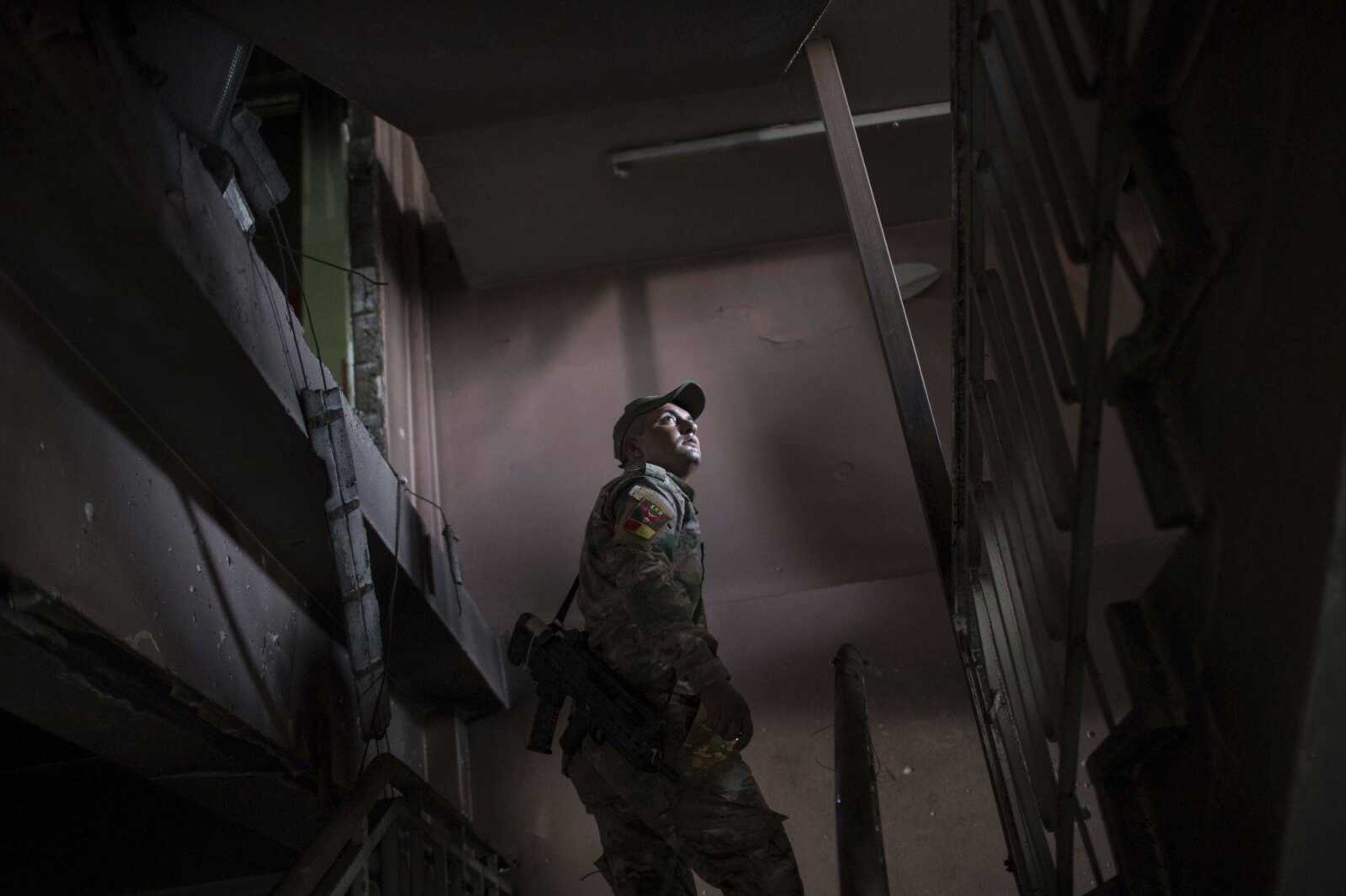 A Federal Police Rapid Response Force fighter walks Tuesday inside a building at Mosul's main hospital complex after it was retaken by Iraqi forces during fighting against Islamic State militants in Mosul, Iraq.