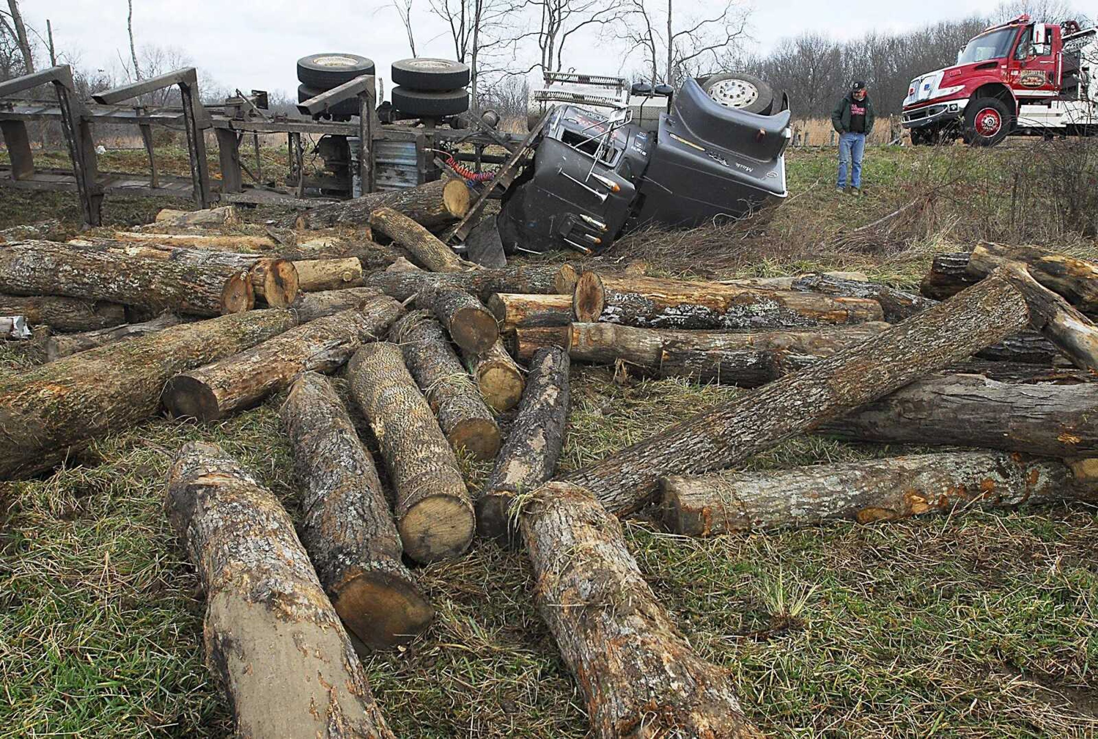 Logs sprawl across a field west of Millersville along Highway 72 Thursday morning, Dec. 3, 2009, after Bobby Gipson lost control of his truck on a curve while headed to Scott City.  It was a single vehicle accident and Gipson suffered minor injuries. (Kit Doyle)