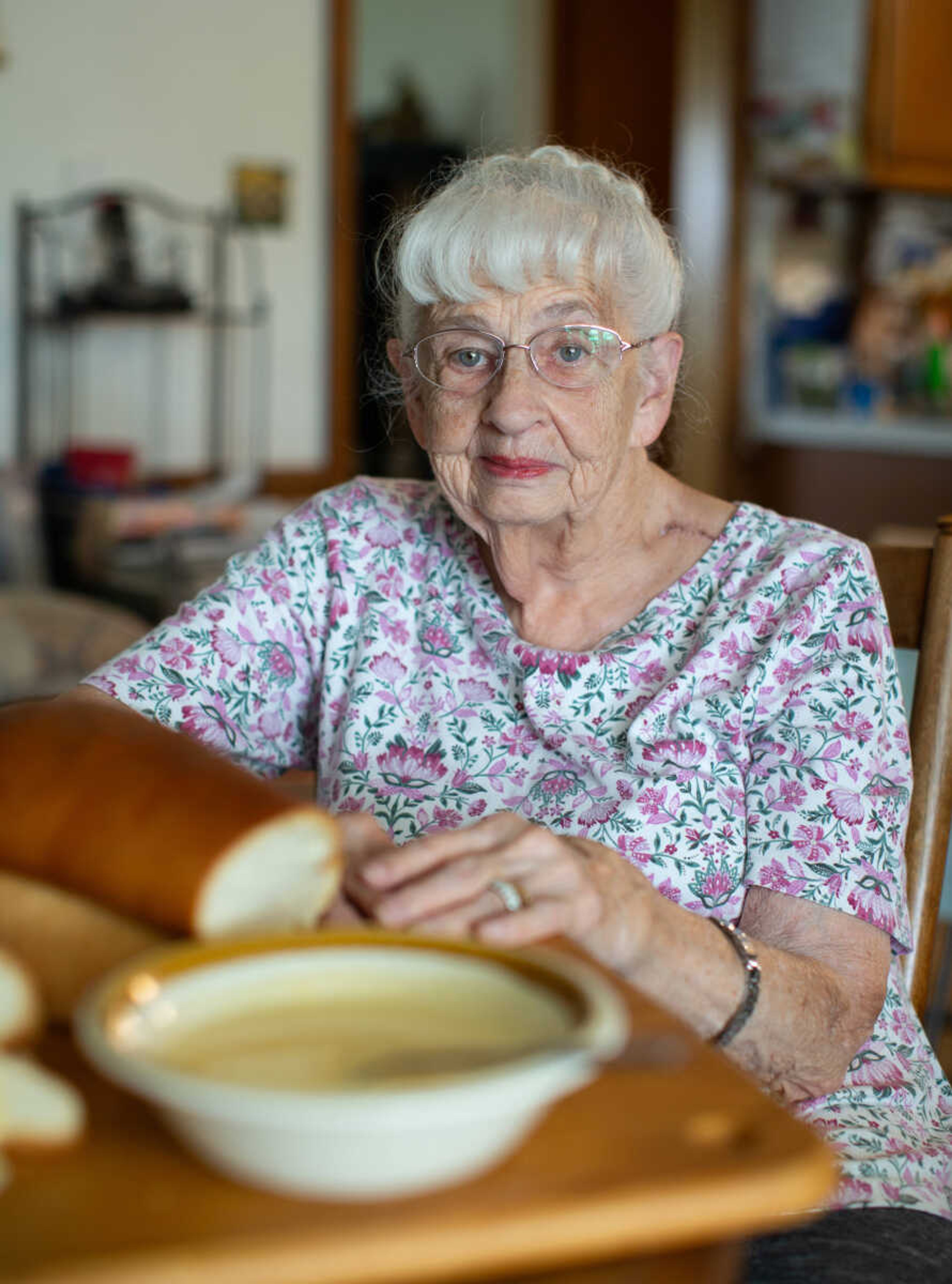 Rosemary Berry sits at her kitchen table in Fruitland, Mo., with a bowl of cooked cheese and a loaf of homemade bread she made. Rosemary has made cooked cheese for St. John's United Church of Christ's sausage suppers in the past.