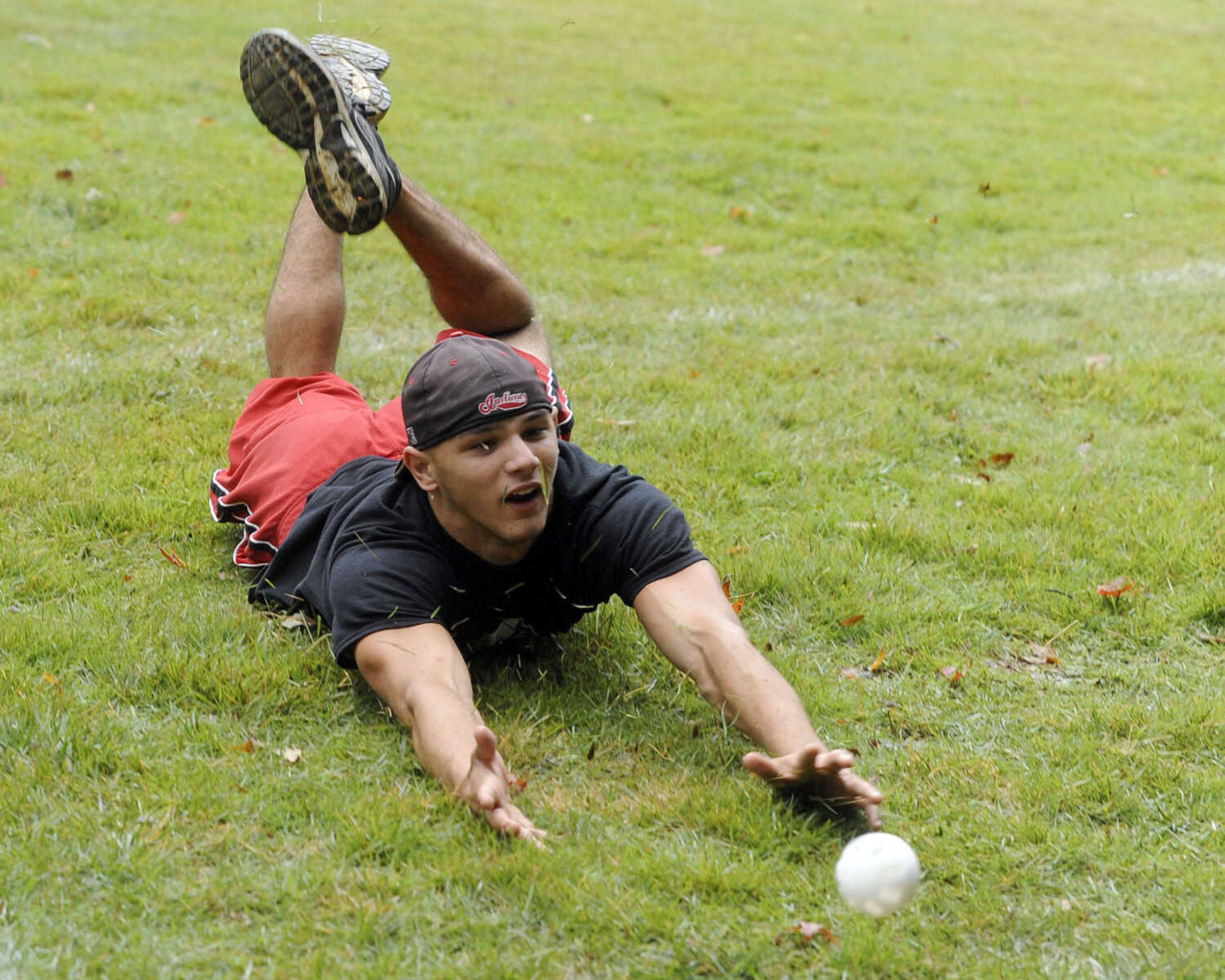 Diablos pitcher Steven Porzelt tries to reach a pop-up foul ball.