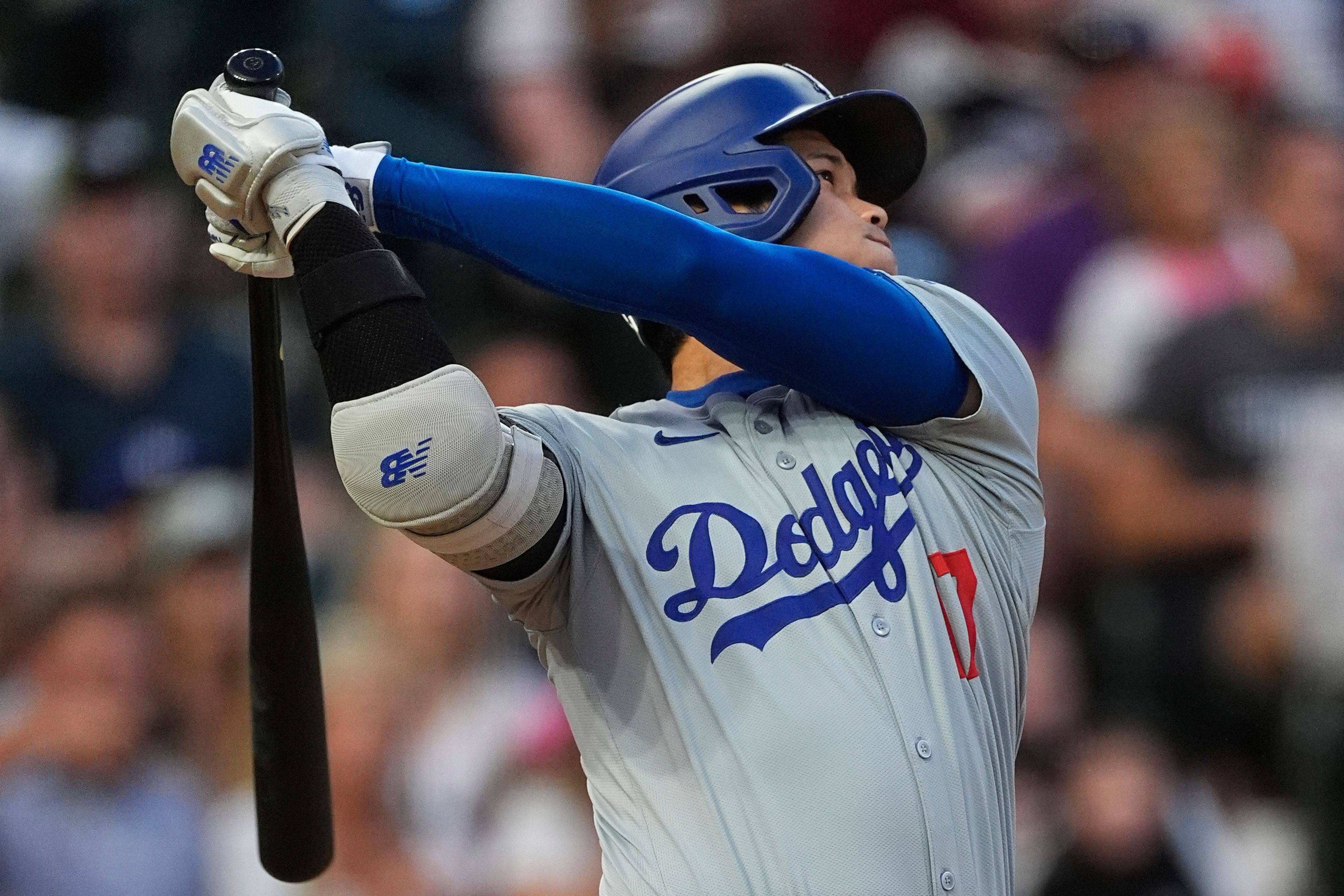 Los Angeles Dodgers' Shohei Ohtani watches his solo home run off Colorado Rockies starting pitcher Austin Gomber during the sixth inning of a baseball game Tuesday, June 18, 2024, in Denver. (AP Photo/David Zalubowski)