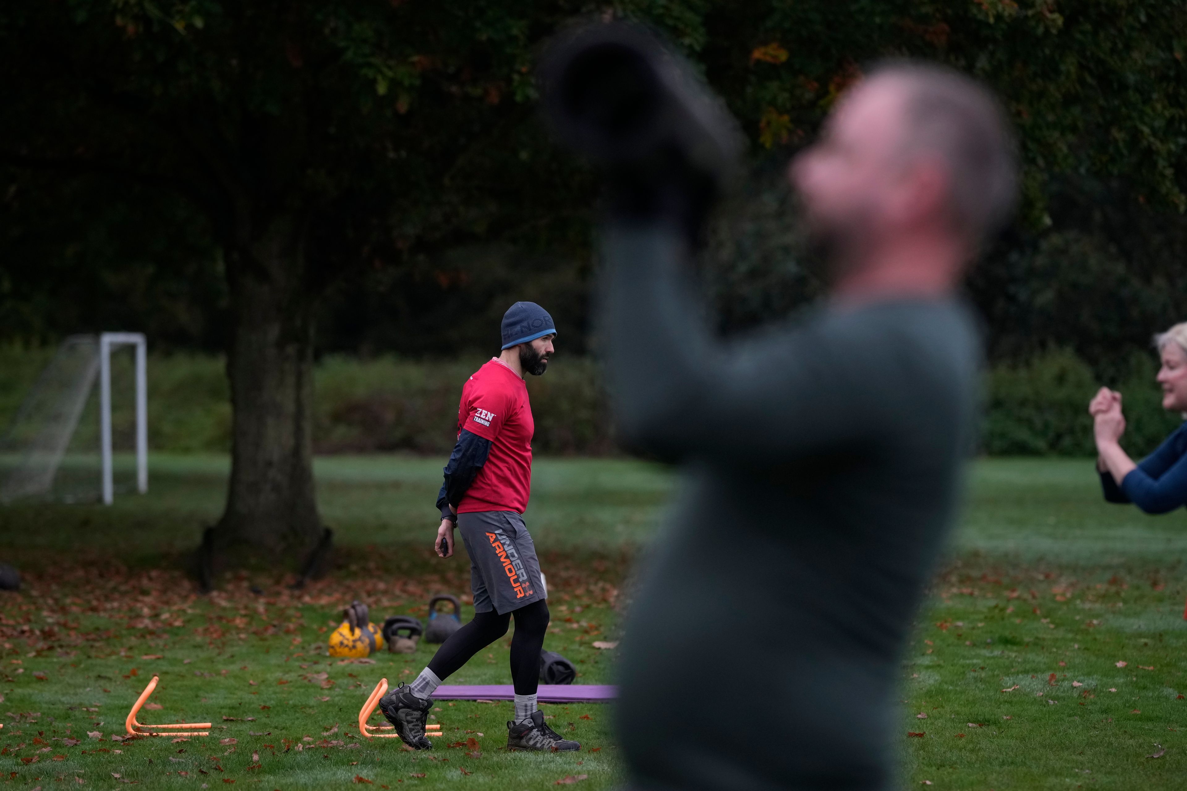 Personal fitness trainer Richard Lamb, leads a group in an outdoor gym class in London, Saturday, Oct. 26, 2024. (AP Photo/Alastair Grant)