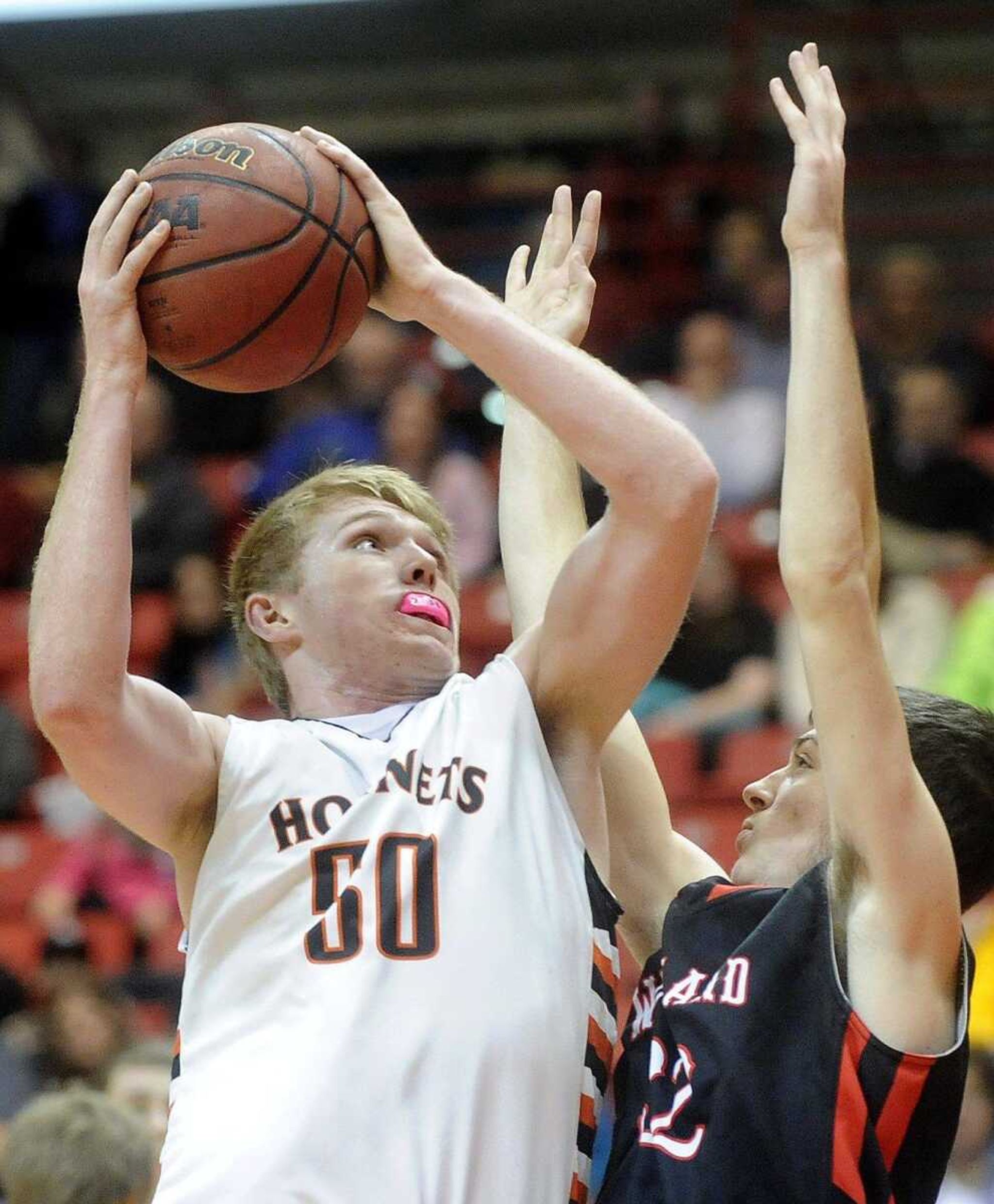 Advance's Dawson Mayo goes in for two-points against Woodland's Devon Gramlisch in the second quarter of a consolation championship game, Monday, Dec. 29, 2014, during the Southeast Missourian Christmas Tournament at the Show Me Center. Woodland won 56-52. (LAURA SIMON)