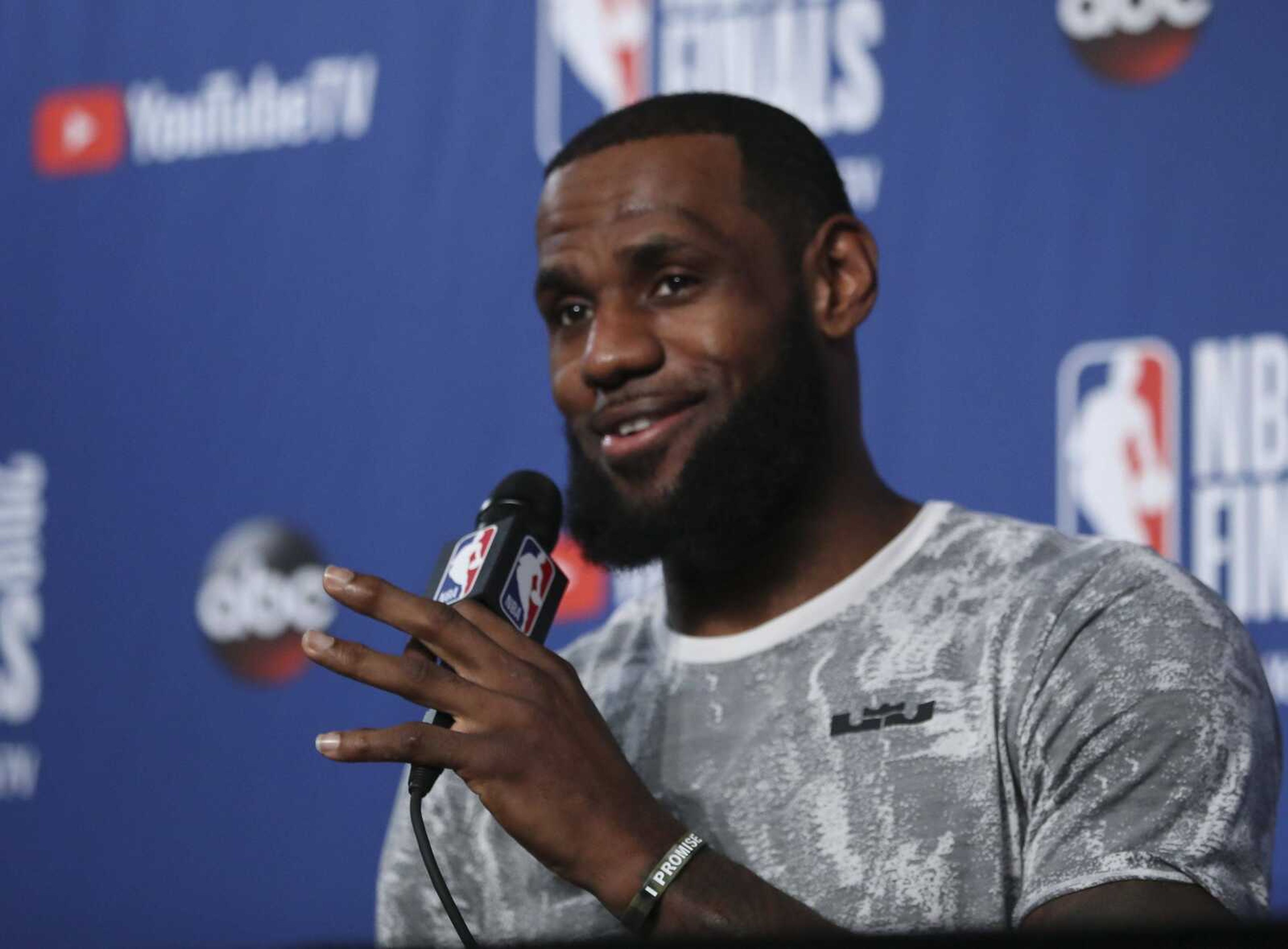 Cleveland Cavaliers forward LeBron James takes questions at a press conference after the basketball team's practice during the NBA Finals in Cleveland. James has been outspoken regarding his feelings toward President Donald Trump, saying he would not attend a White House event if invited.