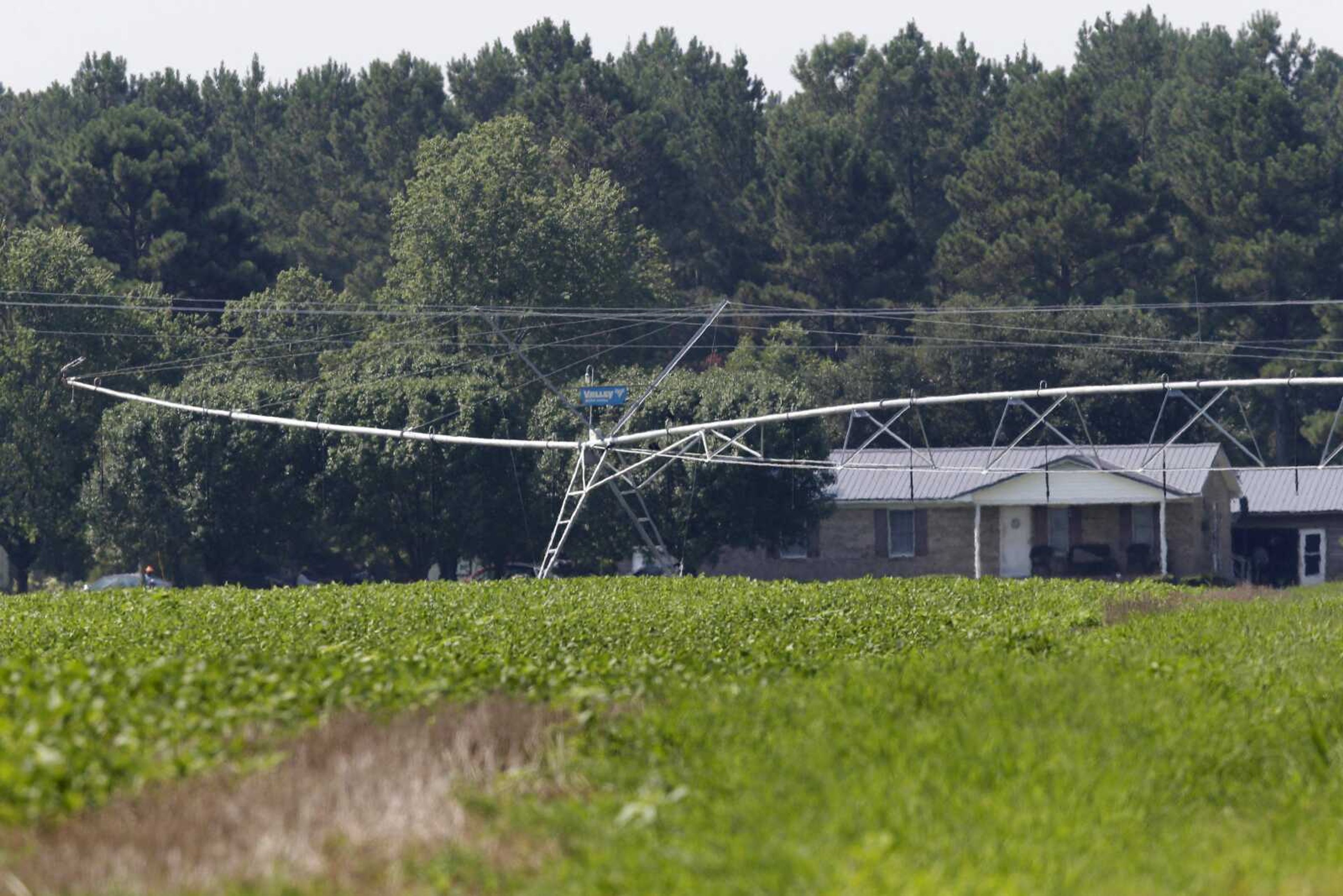 An irrigation system is seen in front of a home across the road from a hog farm owned by Smithfield Foods in Farmville, North Carolina.