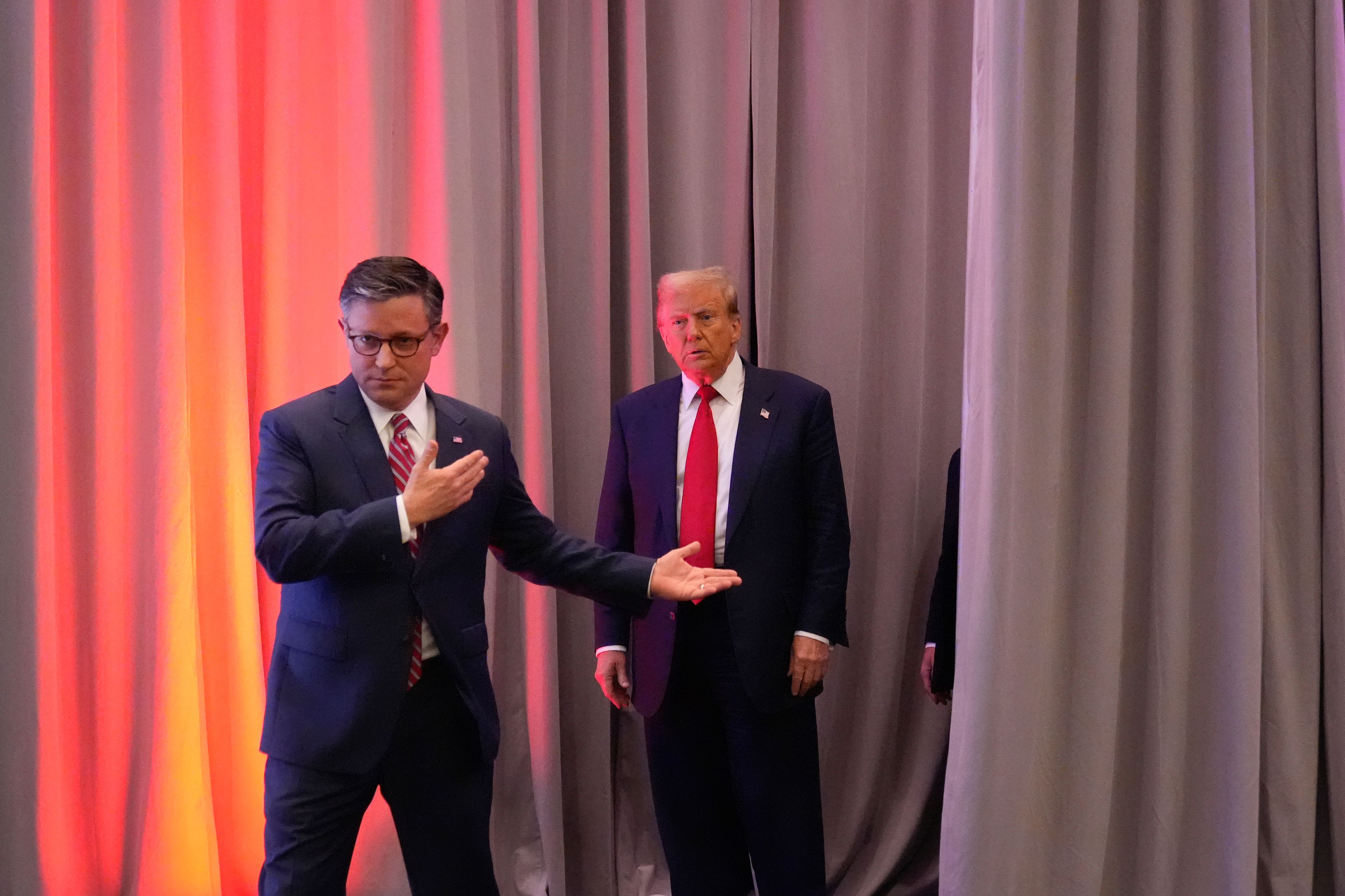 President-elect Donald Trump, escorted by House Speaker Mike Johnson of La., for a meeting with the House GOP conference, Wednesday, Nov. 13, 2024, in Washington. (AP Photo/Alex Brandon)