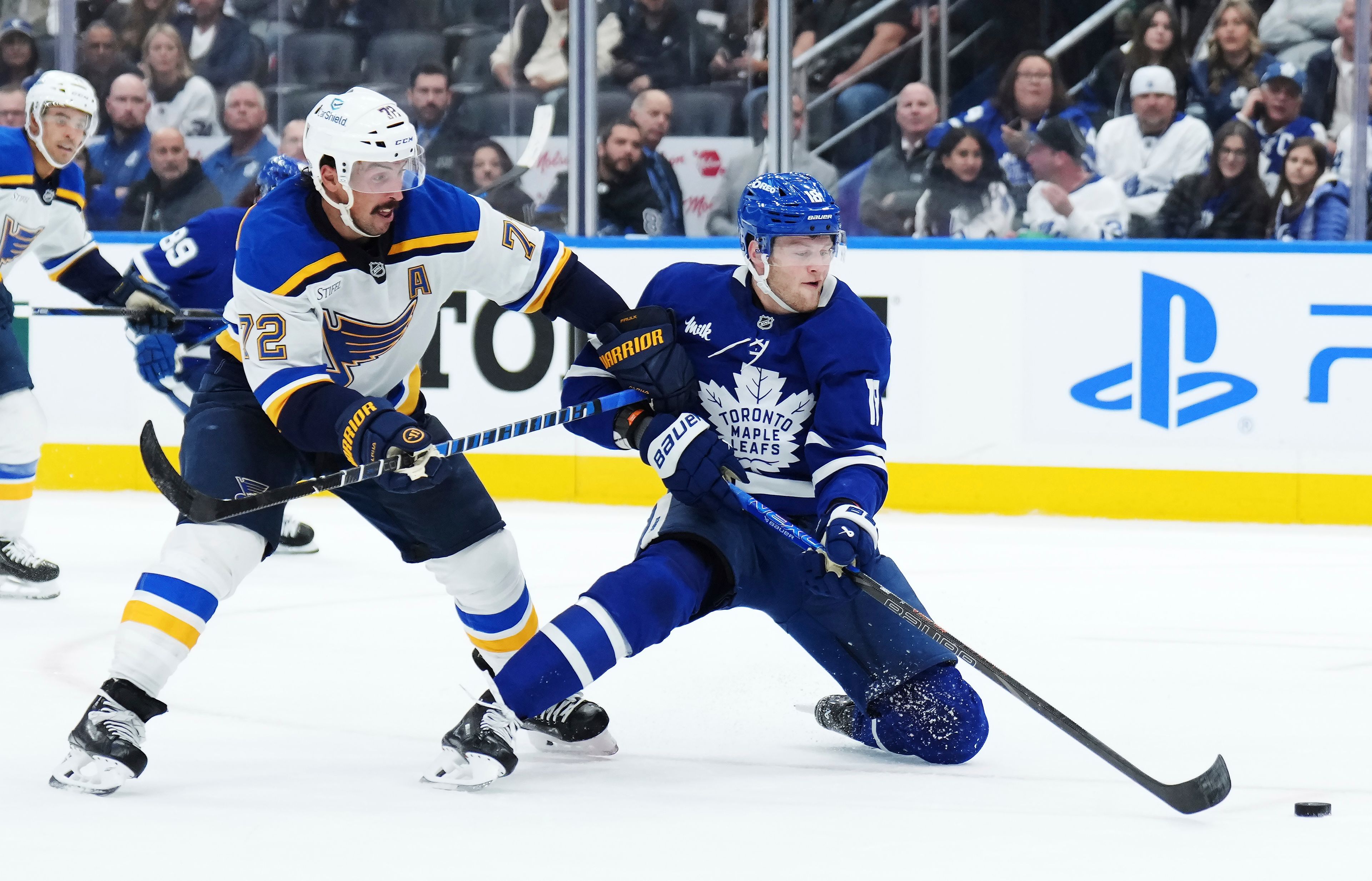 St. Louis Blues defenseman Justin Faulk (72) checks Toronto Maple Leafs forward Steven Lorentz (18) during second-period NHL hockey game action in Toronto, Thursday, Oct. 24, 2024. (Nathan Denette/The Canadian Press via AP)