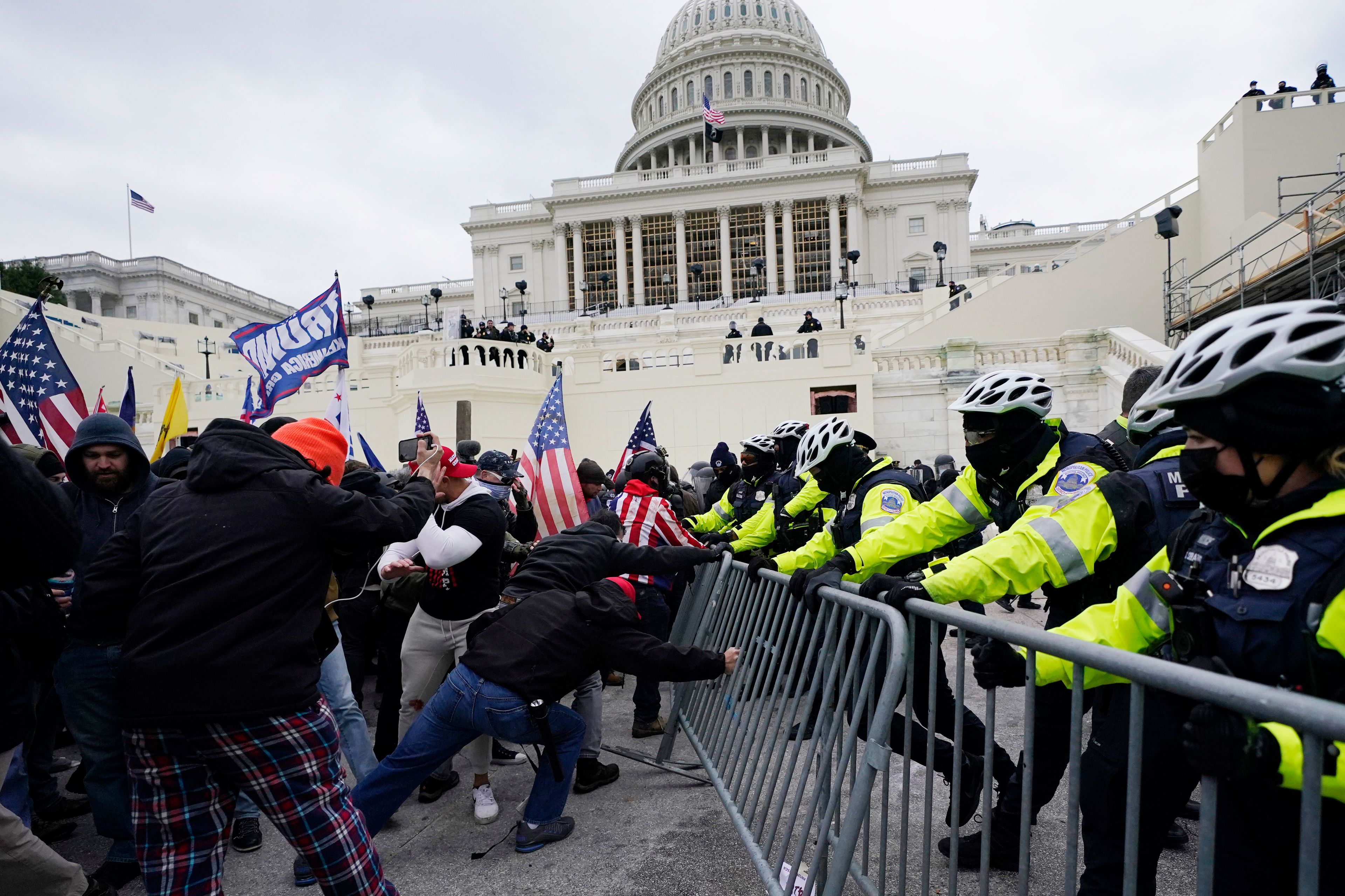 FILE - Violent insurrections loyal to President Donald Trump try to break through a police barrier at the Capitol in Washington on Jan. 6, 2021. (AP Photo/Julio Cortez, File)