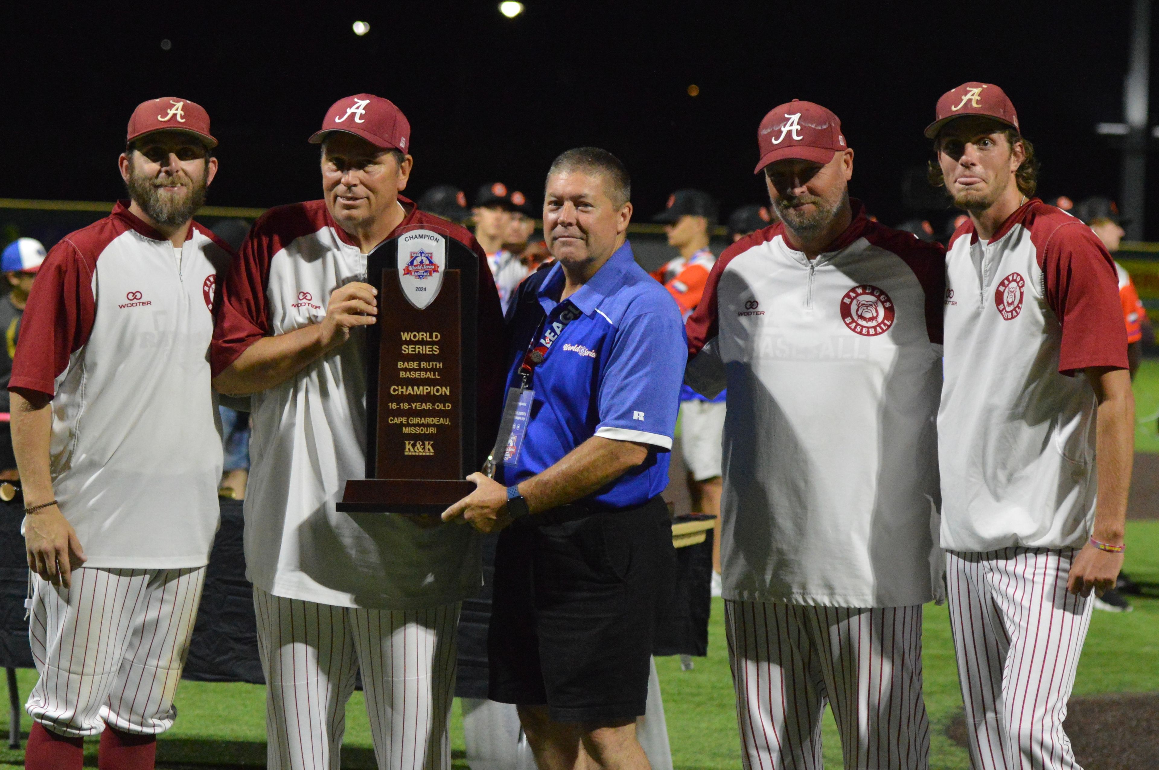 Alabama Rawdogs coaches pose with the Babe Ruth World Series championship trophy on Thursday, Aug. 15, at Capaha Field in Cape Girardeau, Mo. 