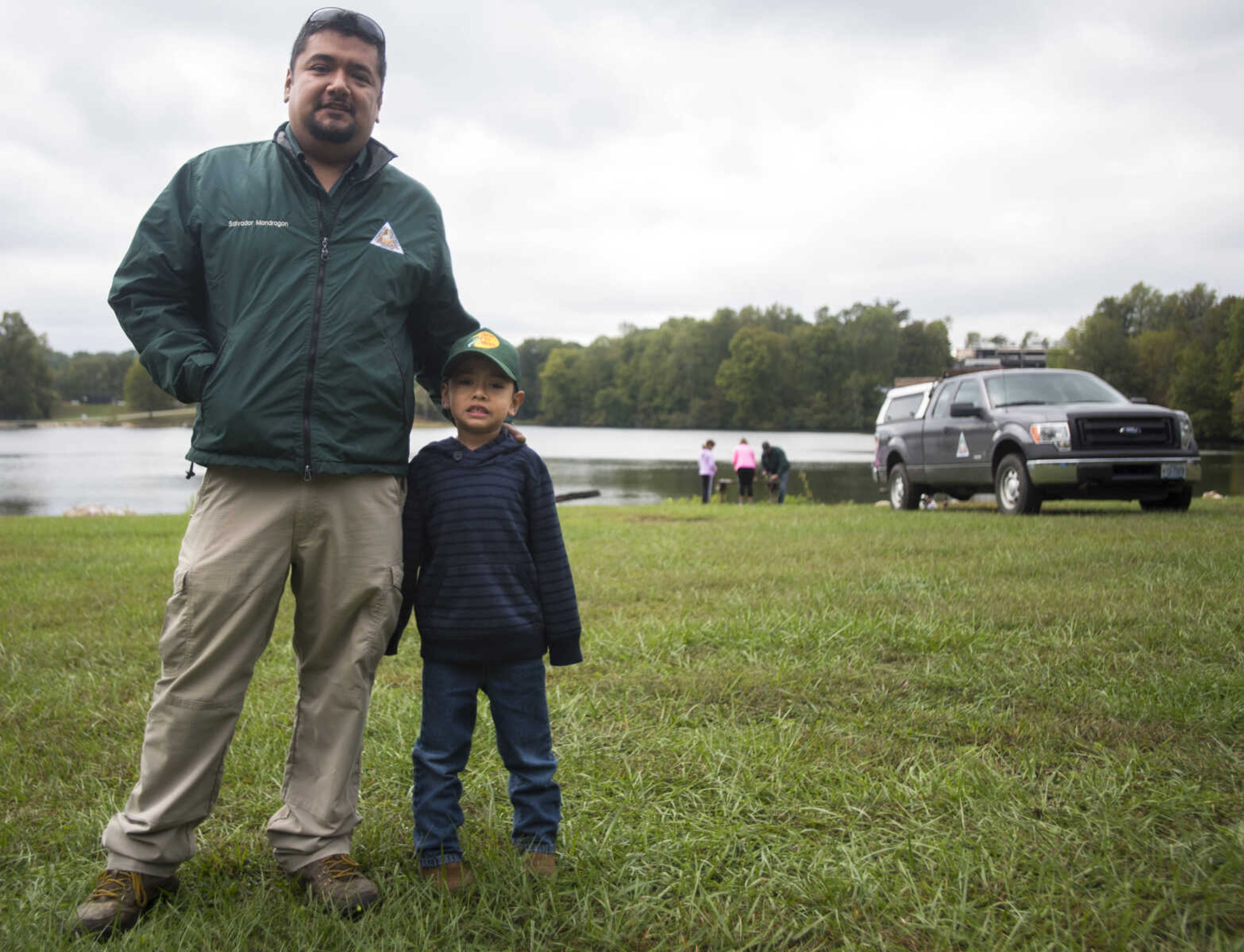 Salvador Mondragon and his son, Andy, 5, stand in front of Elks Lake during the inaugural Fishing Rodeo held Oct. 15, 2017 in Cape Girardeau.