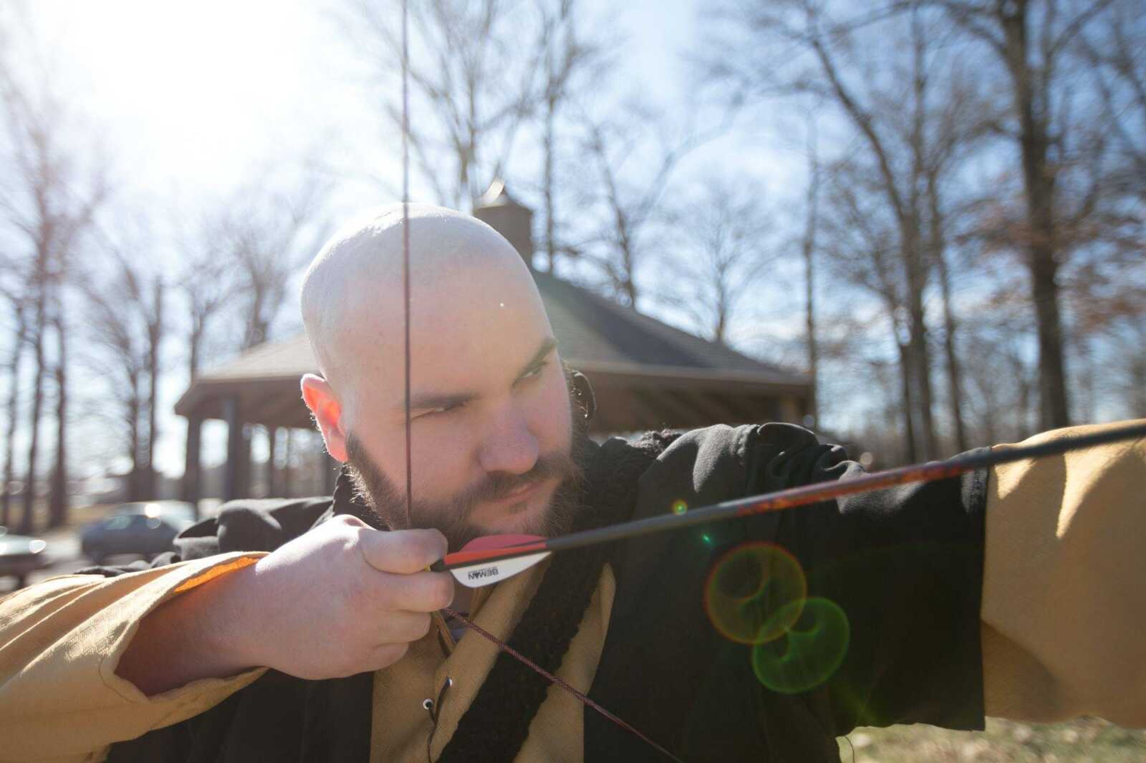 Andrew Litzelfelner draws a bow back to fire a modified arrow during an Amtgard practice Saturday at Arena Park in Cape Girardeau.