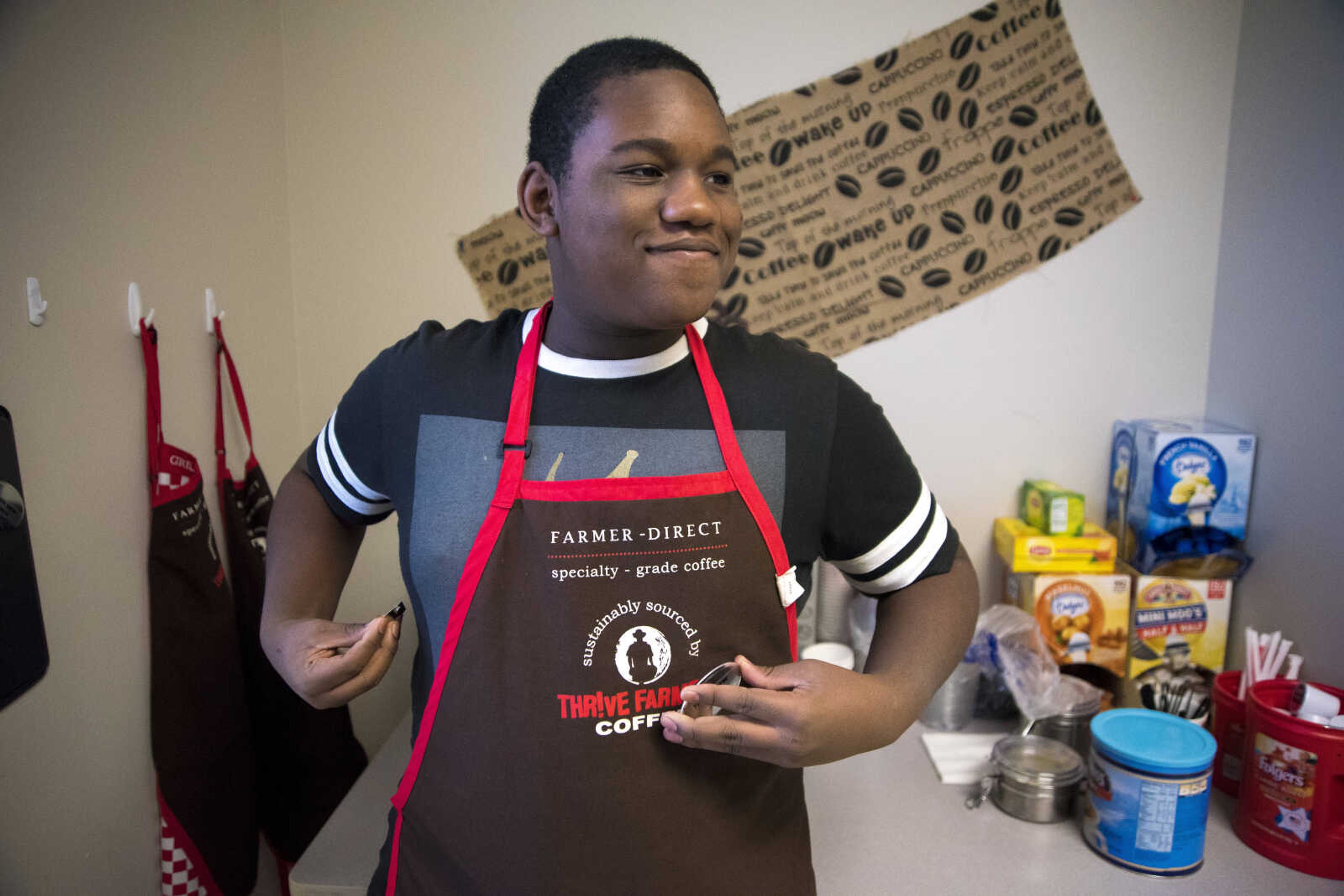 ANDREW J. WHITAKER ~ awhitaker@semissourian.com
Tim Dickinson puts on his apron before he makes drinks for Tiger Brew, a student run business run by the special education department at Cape Girardeau Central, Tuesday, Dec. 13, 2016 in Cape Girardeau. Tiger Brew is available Monday through Friday during three different class periods, 1st hour, 2nd hour and advisory and offer a variety of drinks from hot coffees and teas, iced drinks, hot chocolates and even smoothies.