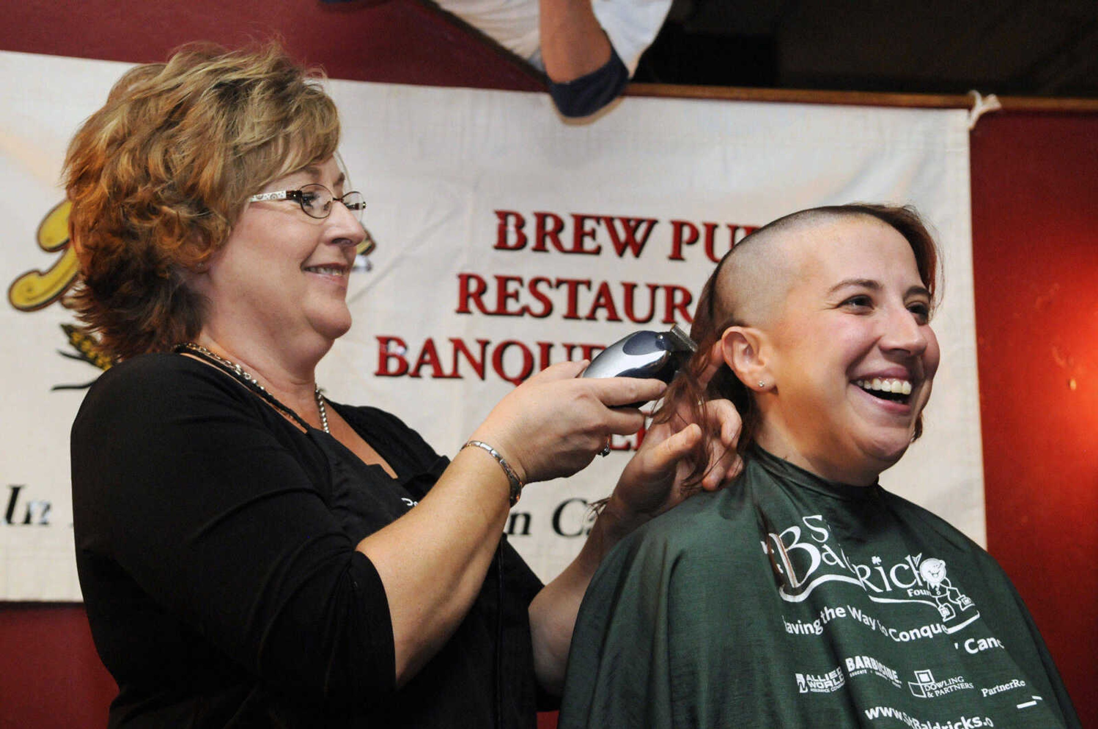 KRISTIN EBERTS ~ keberts@semissourian.com

Robin Shy smiles as Laura Green of the JCPenney Salon shaves her head during the St. Baldrick's event at Buckner Brewing Company in Cape Girardeau, Mo., on Saturday, April 24, 2010. Robin was the only female to shave her head, and did so after reaching her goal of raising $500. Twenty-five area participants raised over $9,000 collectively before shaving their heads to benefit the St. Baldrick's Foundation for child cancer research.