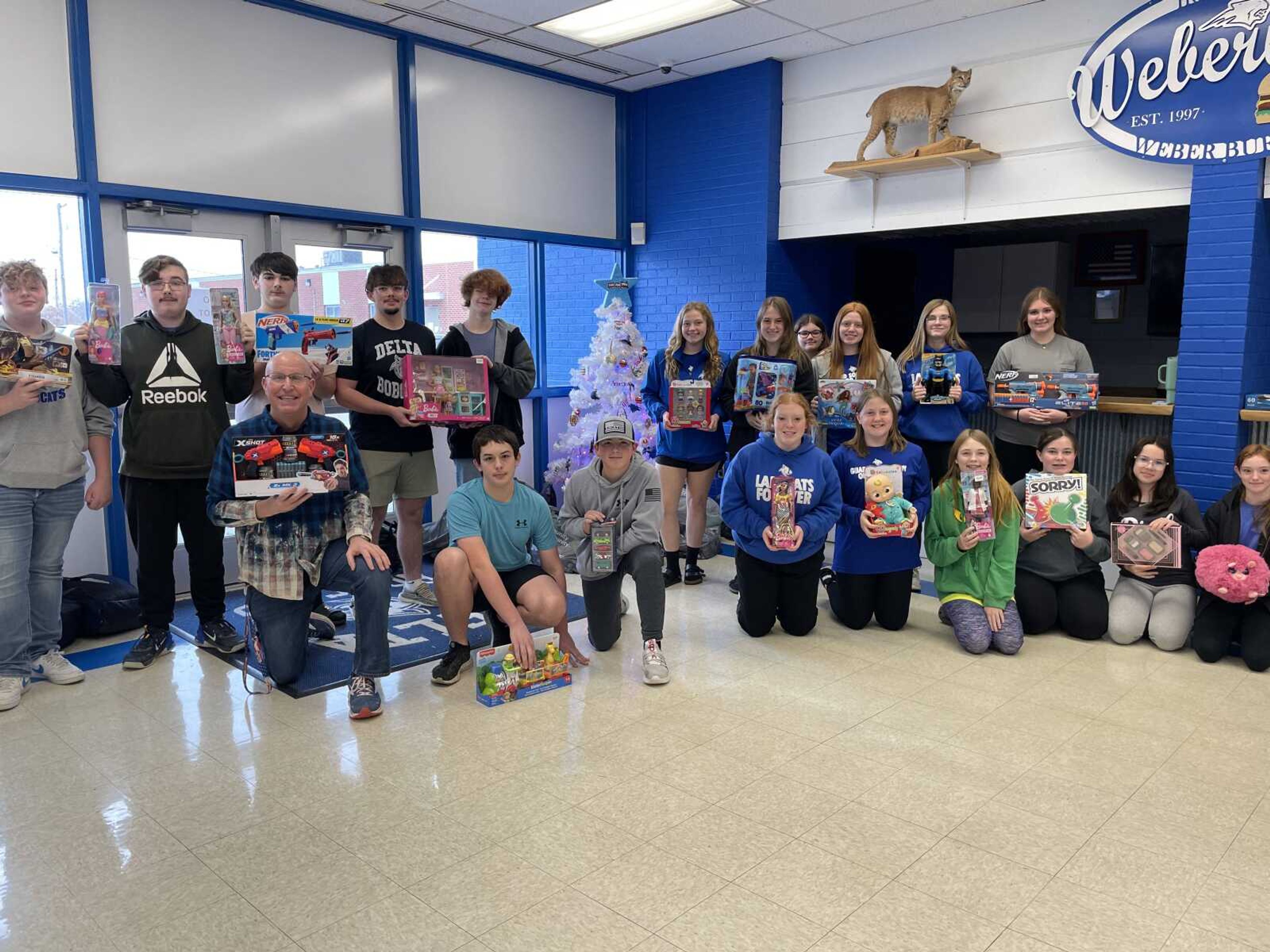 Delta High School Student Council members gathered around the Toys for Tots donation tree.