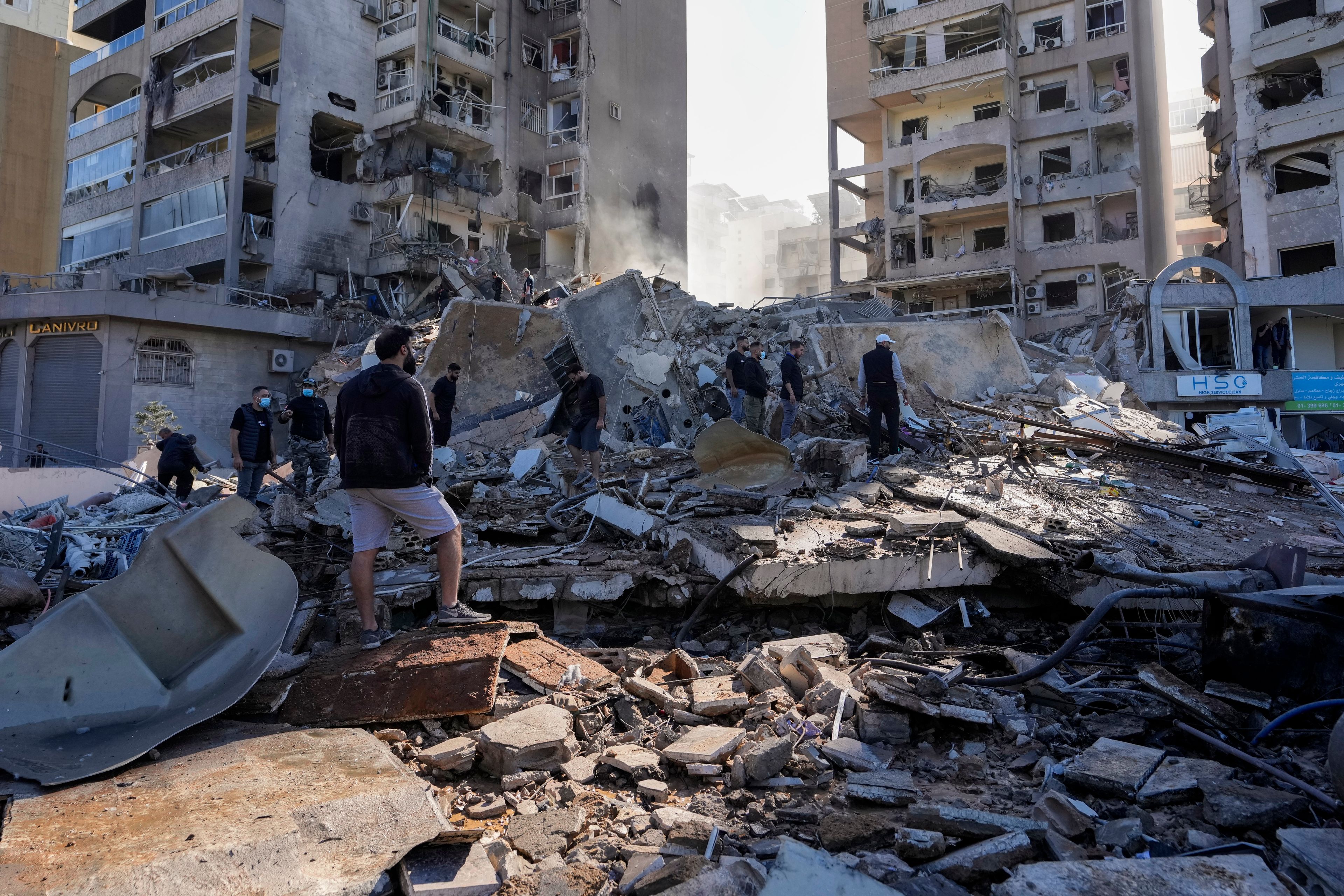 Residents check the site of an Israeli airstrike in Tayouneh, Beirut, Lebanon, Friday, Nov. 15, 2024. (AP Photo/Hassan Ammar)