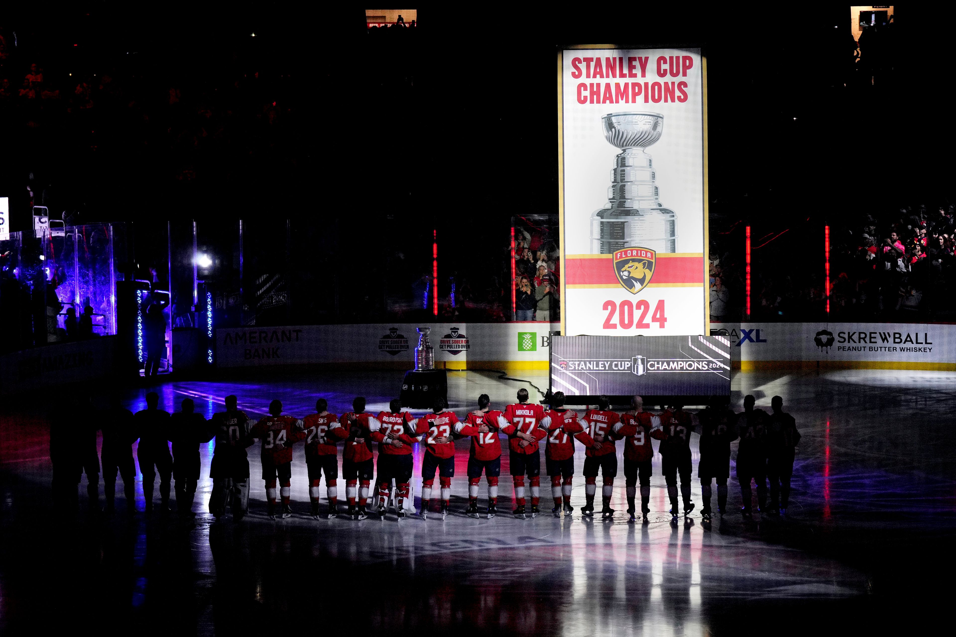 The Florida Panthers raise their Stanley Cup championship banner before the start of the NHL hockey game against the Boston Bruins, Tuesday, Oct. 8, 2024, in Sunrise, Fla. (AP Photo/Jim Rassol)