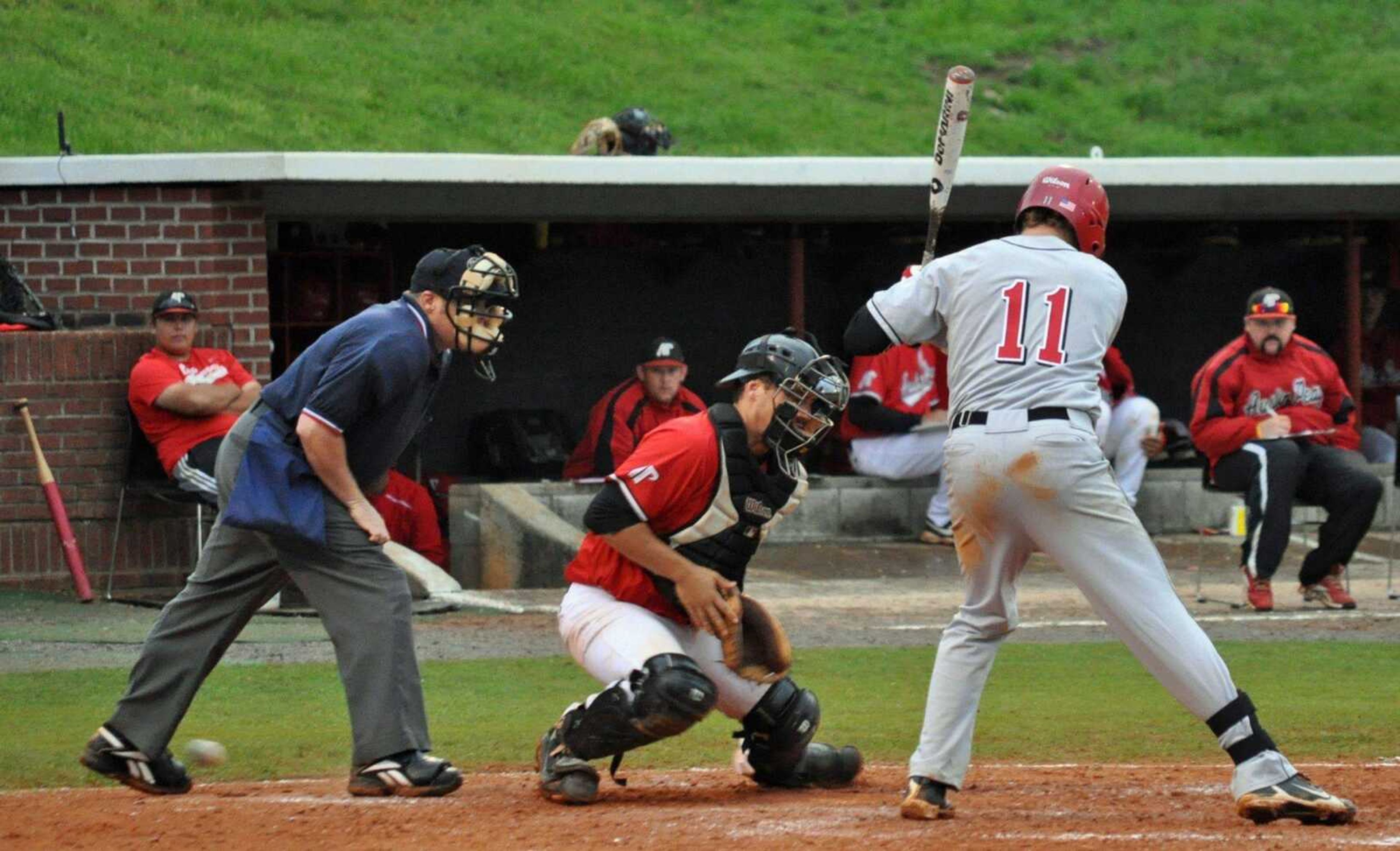 A wild pitch skips through the legs of Austin Peay catcher