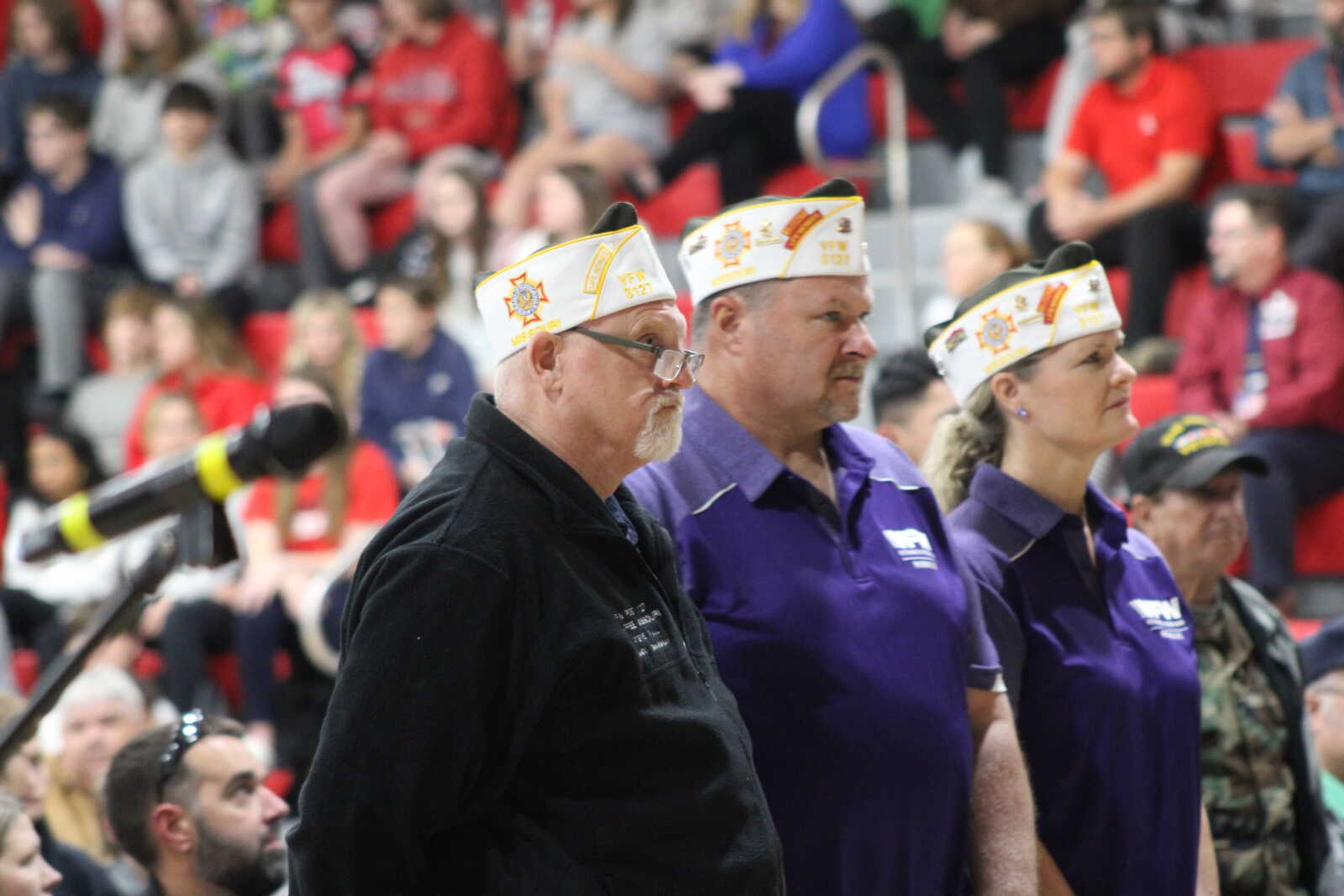 Veterans in attendee stand when their branch is called during the Armed Forces on Parade played by the Chaffee High school band.&nbsp;