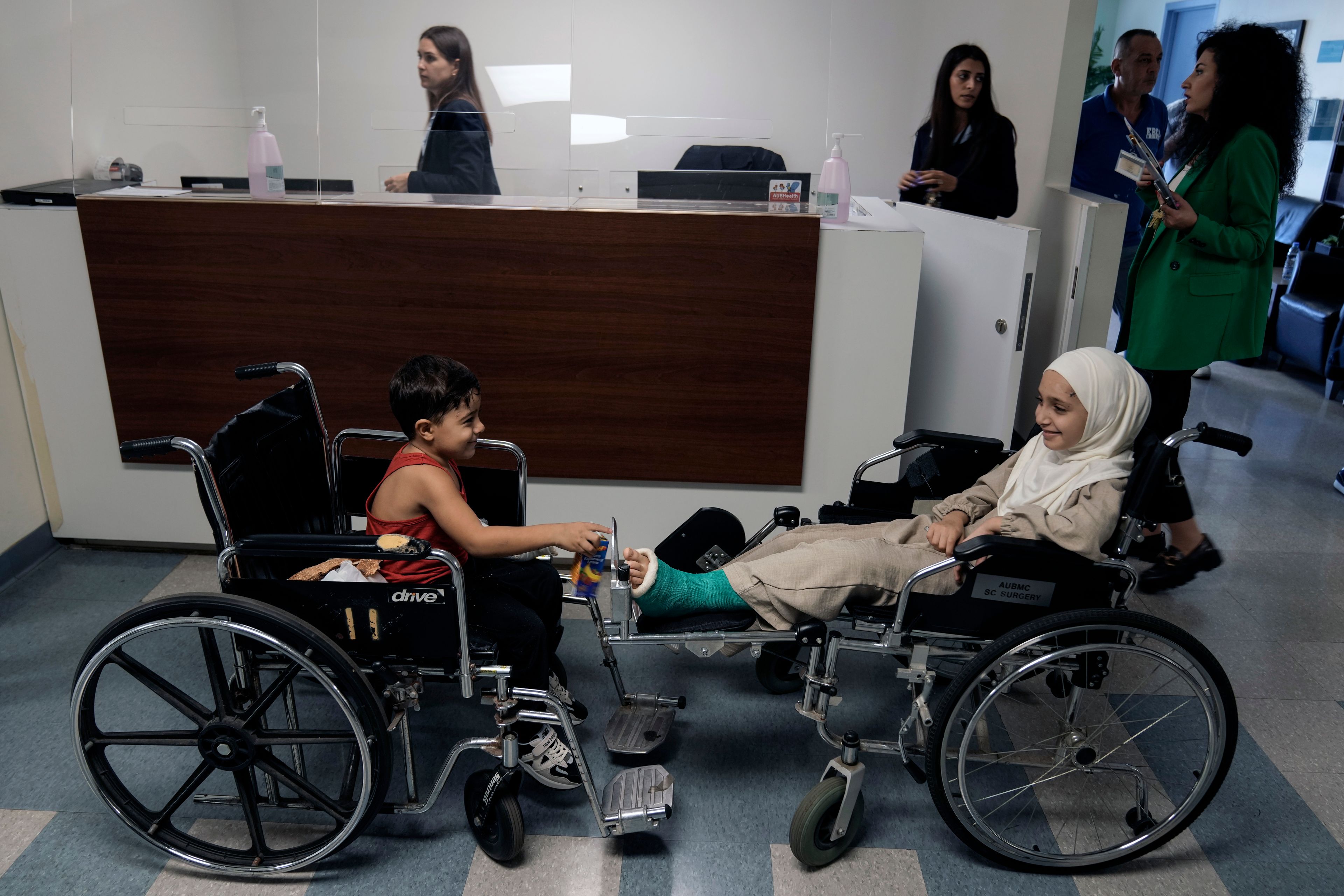 Hussein Mikdad, 4, left, and his cousin Zahraa, right, who were injured on Oct. 2 in an Israeli airstrike at a densely-populated neighborhood south of Beirut, sit on their wheelchairs as they wait to be seen by their doctor at American University of Beirut Medical Center (AUBMC), in Beirut, Lebanon, Tuesday, Nov. 5, 2024. (AP Photo/Bilal Hussein)