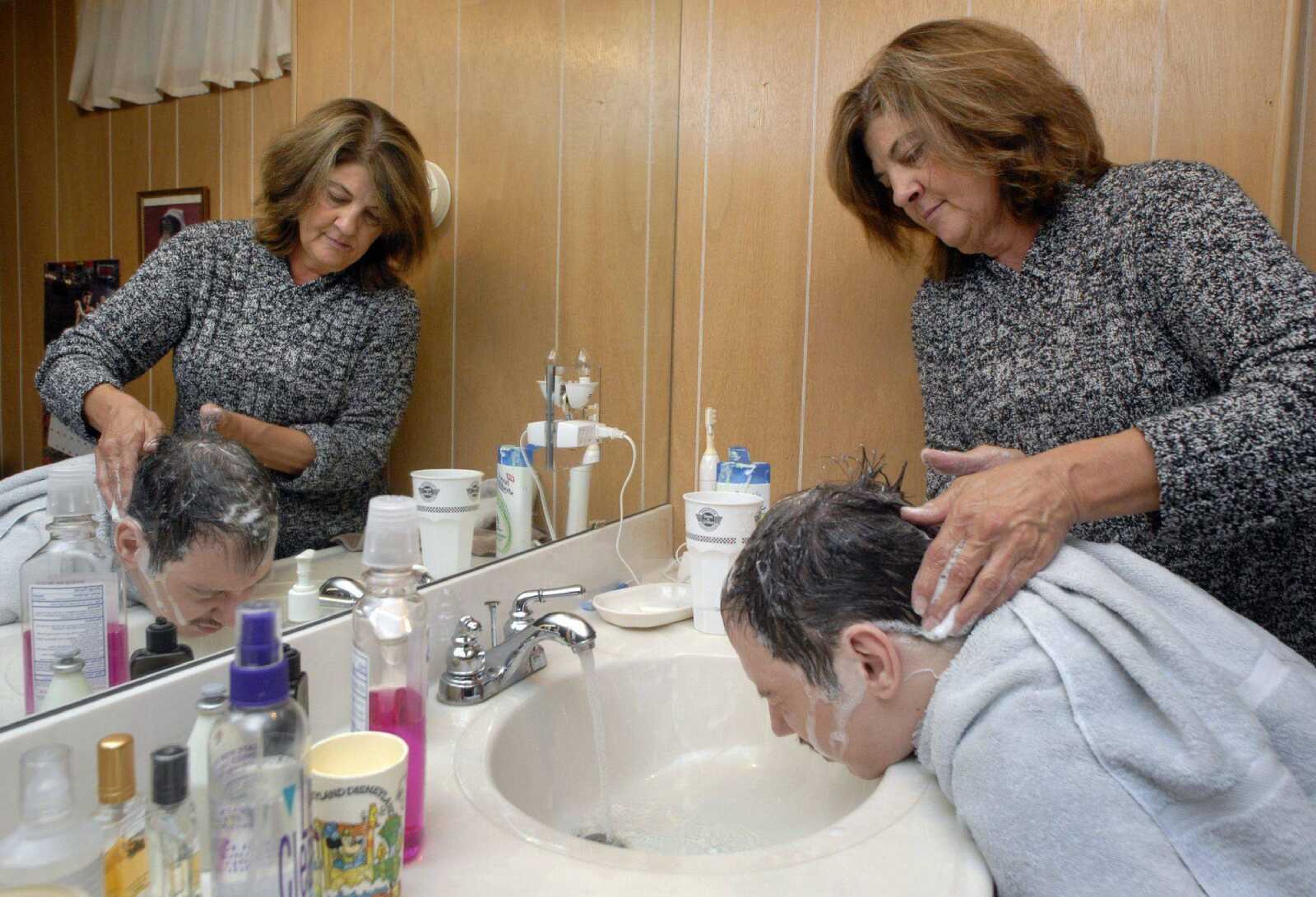 FRED LYNCH ~ flynch@semissourian.com
Janet Miller washes Shane Sinn's hair in his home where she works as his attendant five days a week.